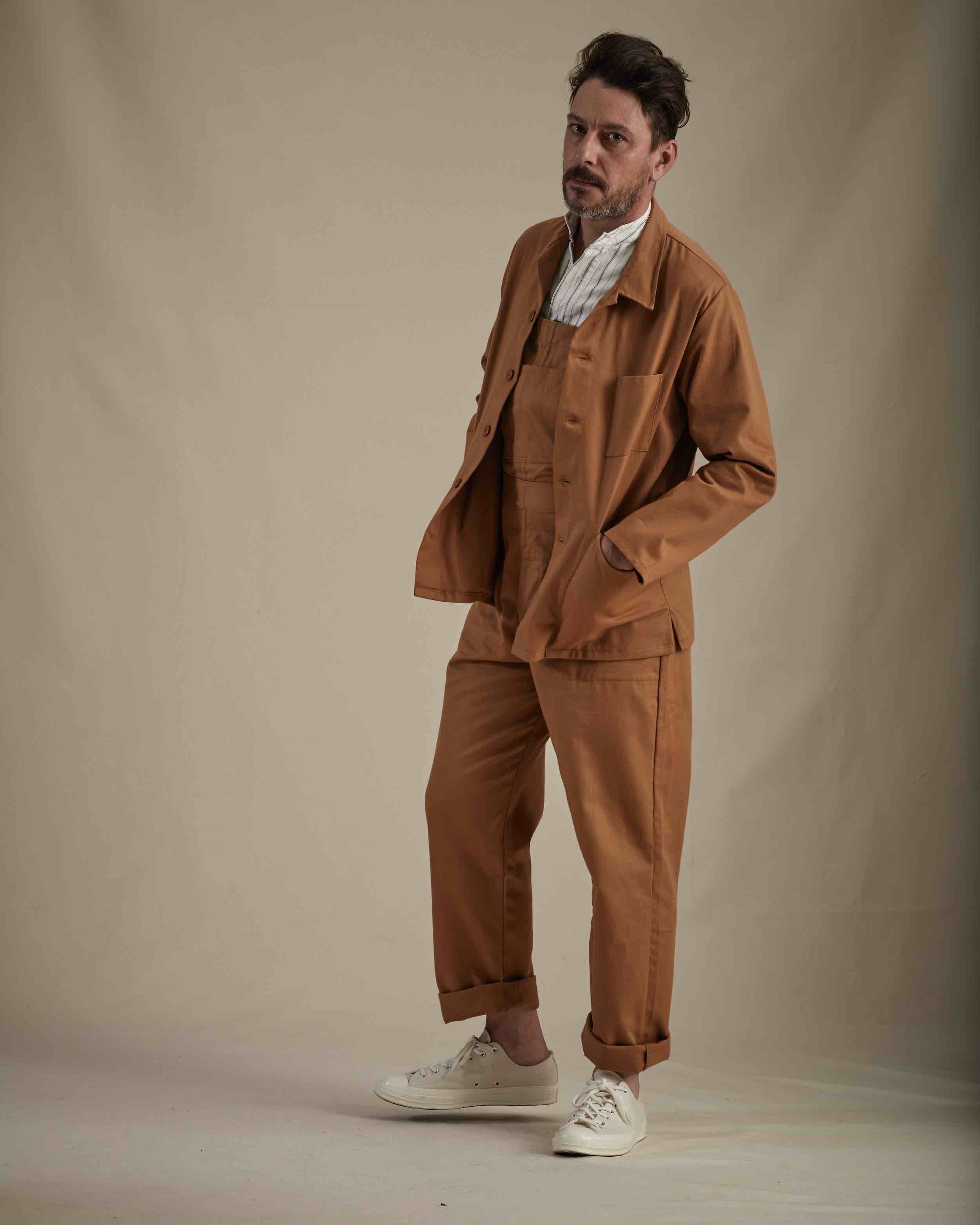 Man wearing Carrier Company Work Jacket in Tan with Men's Dungarees