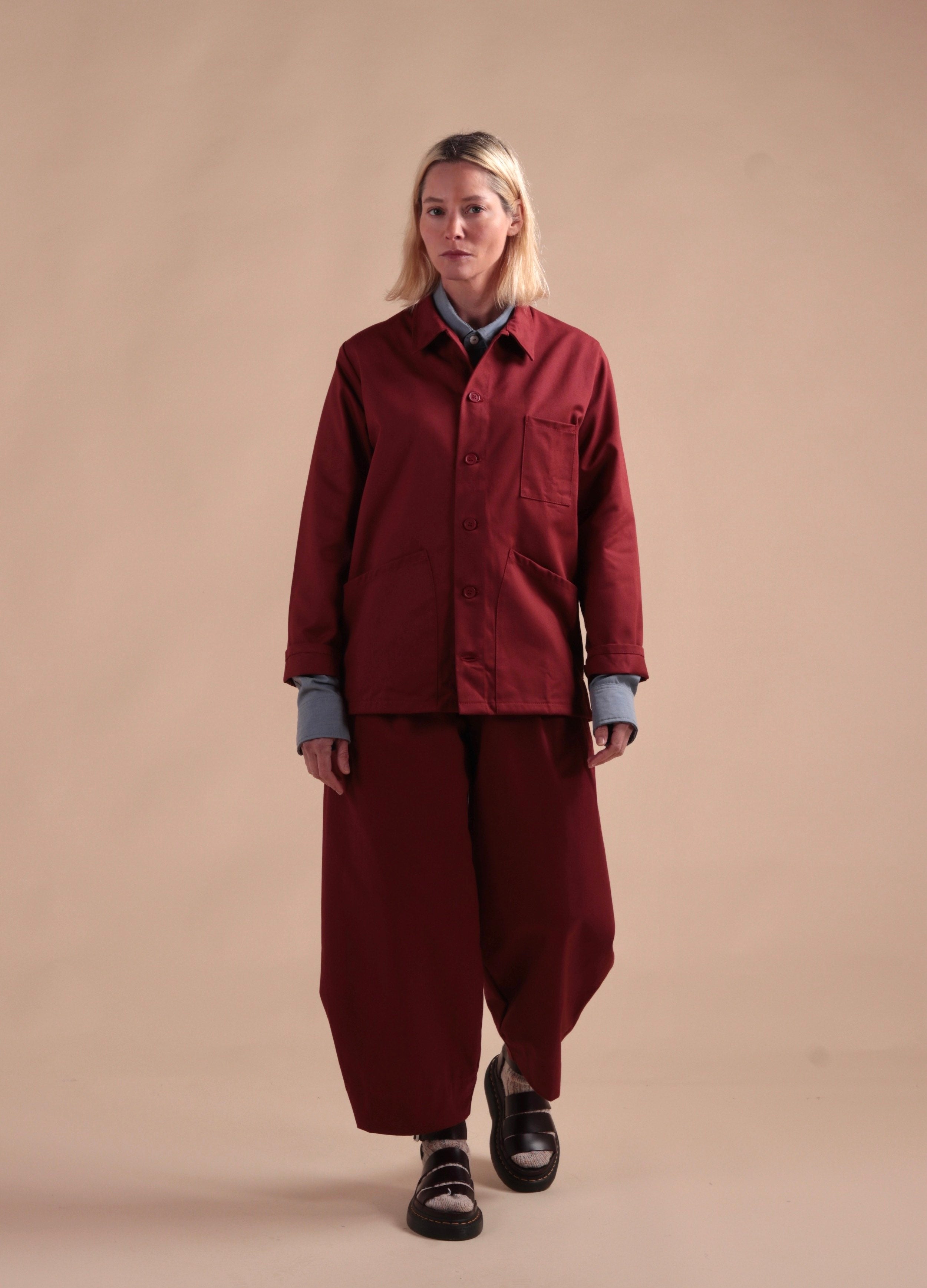 Sienna wears Carrier Company Dutch Trouser in Breton red with Norfolk Work Jacket in Breton Red and Navy Cardigan