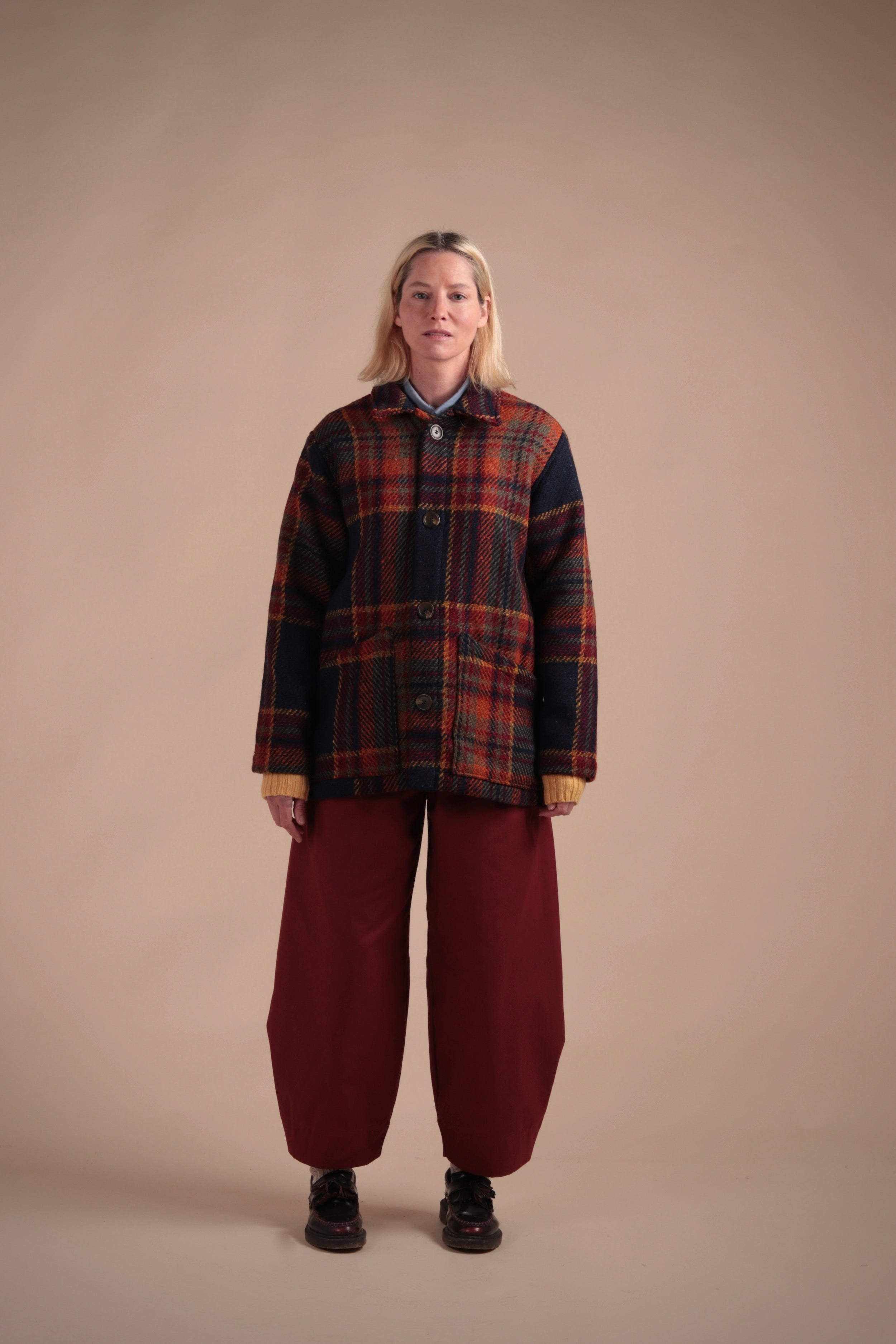 Woman wears Carrier Company Celtic Wool Jacket in Navy and Rust with Breton Red Dutch Trouser in Cotton Drill
