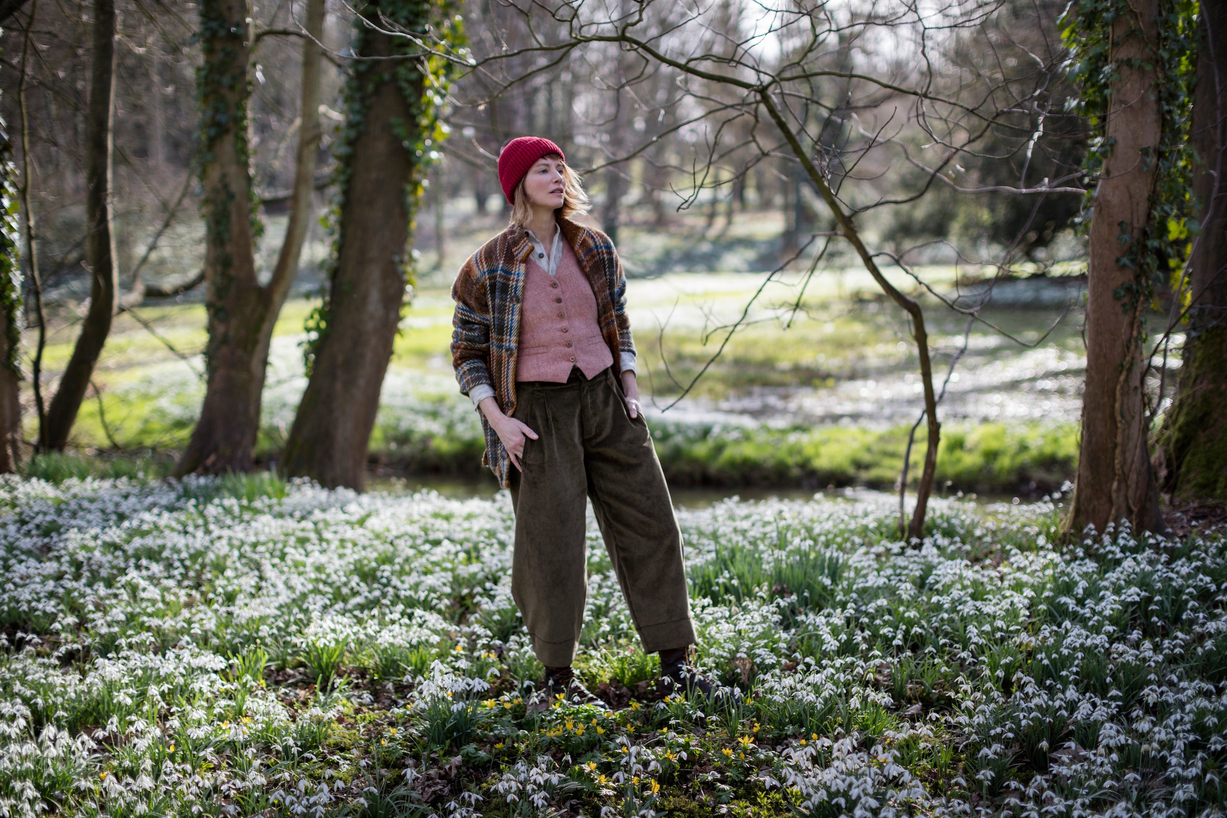 Woman wearing Carmine Donegal Wool Hat, Russet Celtic Wool Jacket and Corduroy Dutch Trouser
