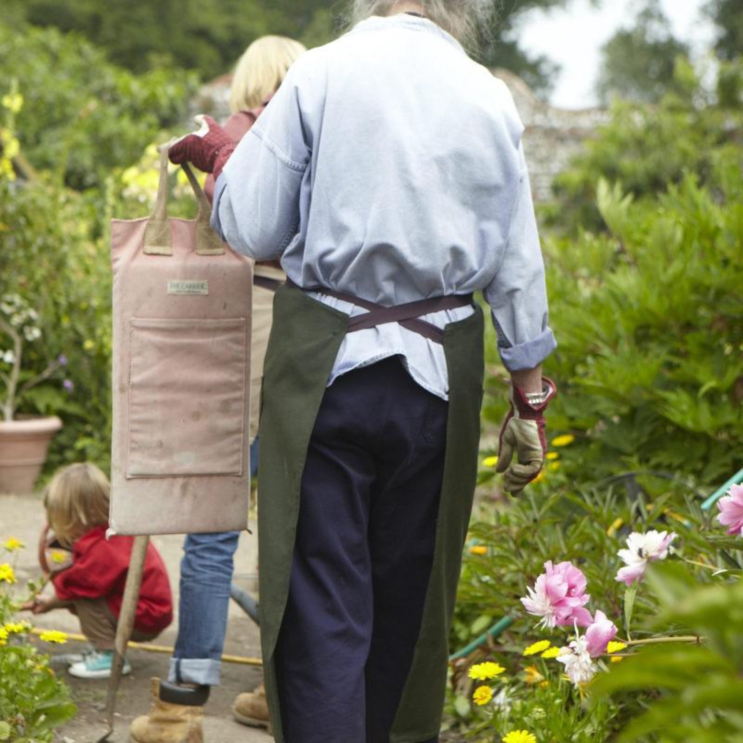 Gardener holding Carrier Company Garden Kneeler