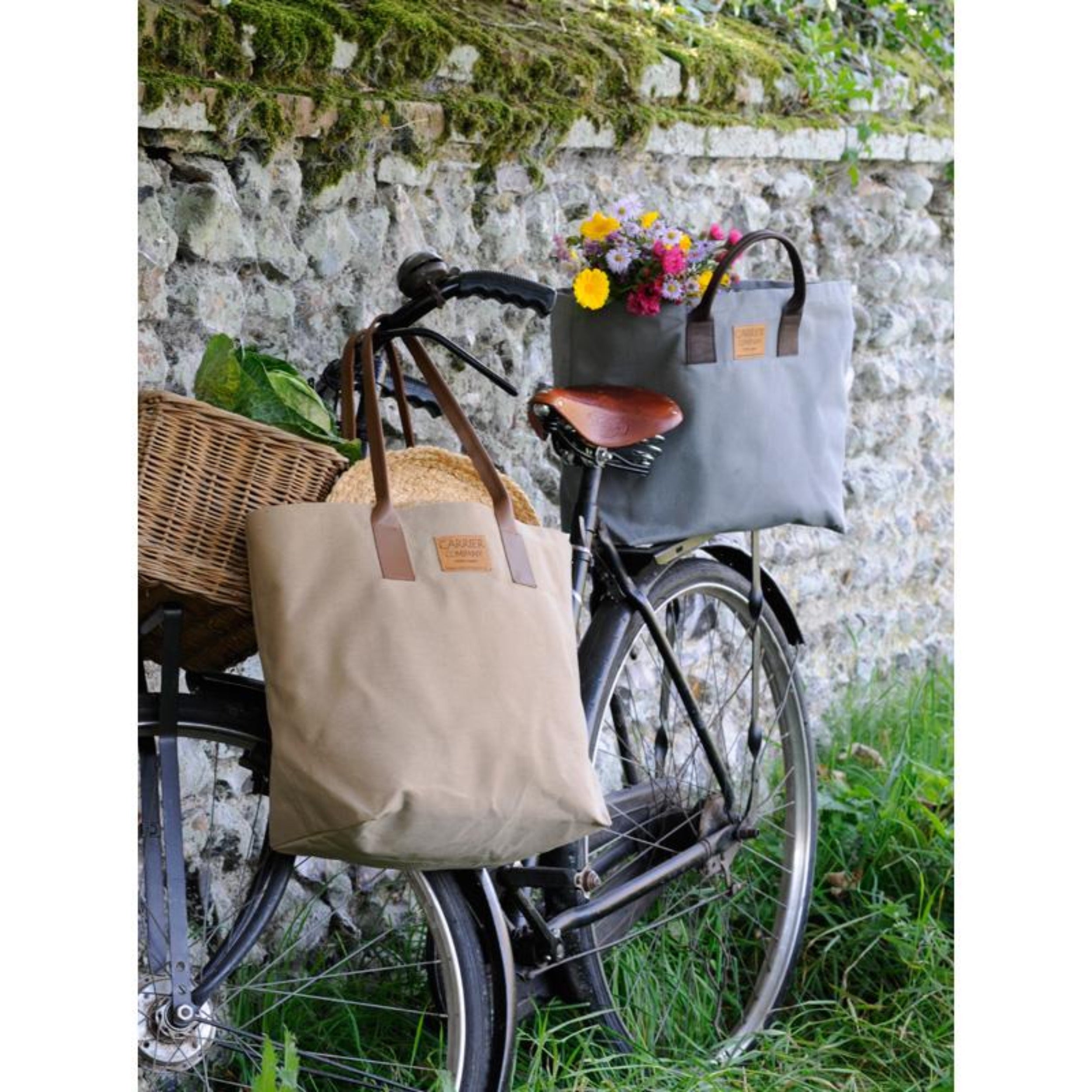 Carrier Company Leather Handled Sturdy Bag s cradled over a Bicycle