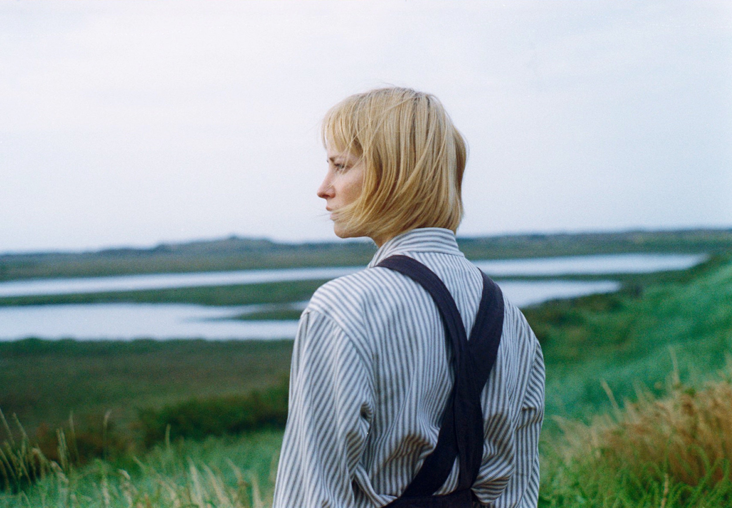 Sienna wears Carrier Company Collarless Workshirt in Indigo Ticking