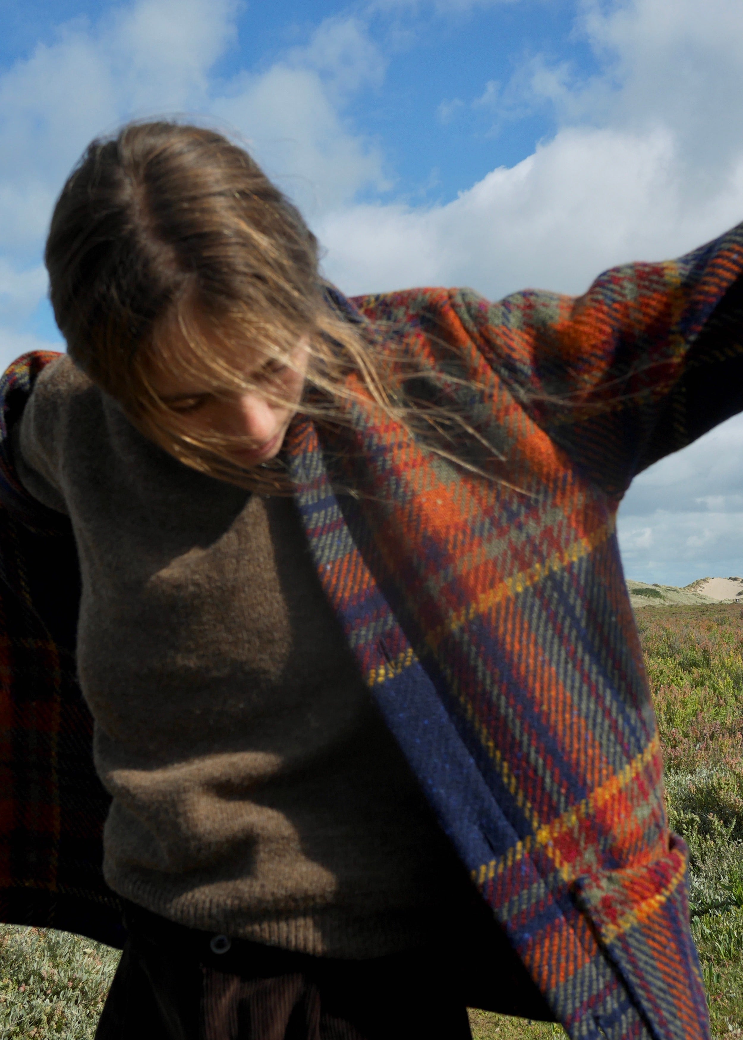 Woman wears Carrier Company Celtic Wool Jacket in Navy and Rust with Shetland Lambswool Jumper and Dutch Trouser in Corduroy