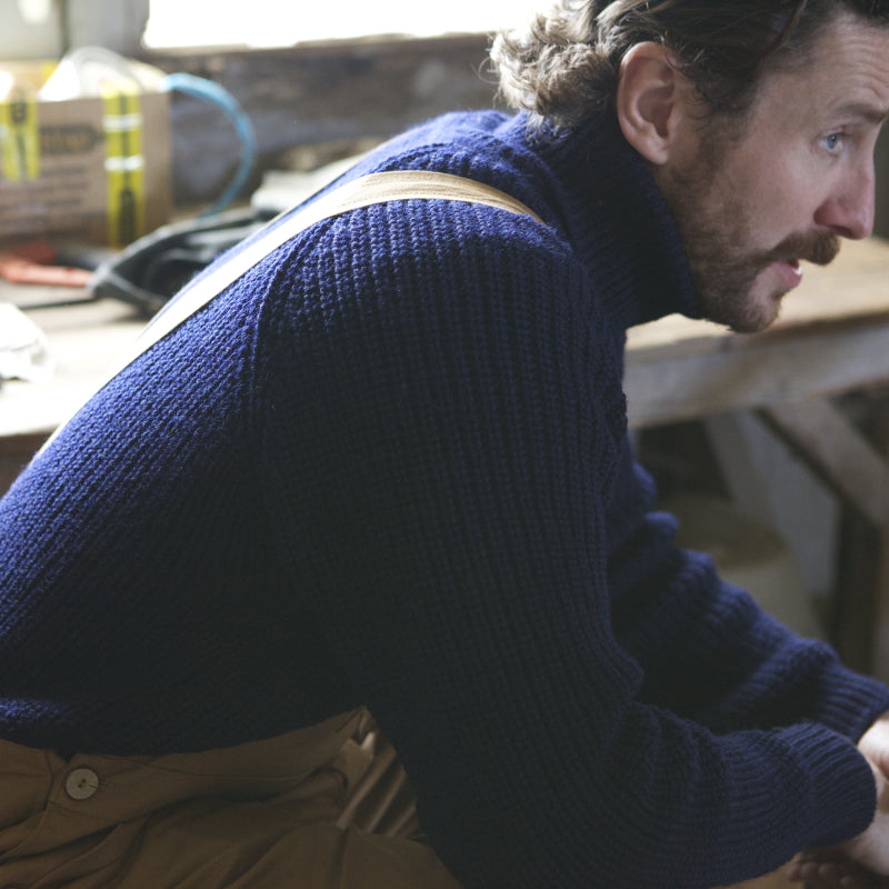 Man wearing Carrier Company Fisherman's Roll Neck Jumper and Tan Dungarees