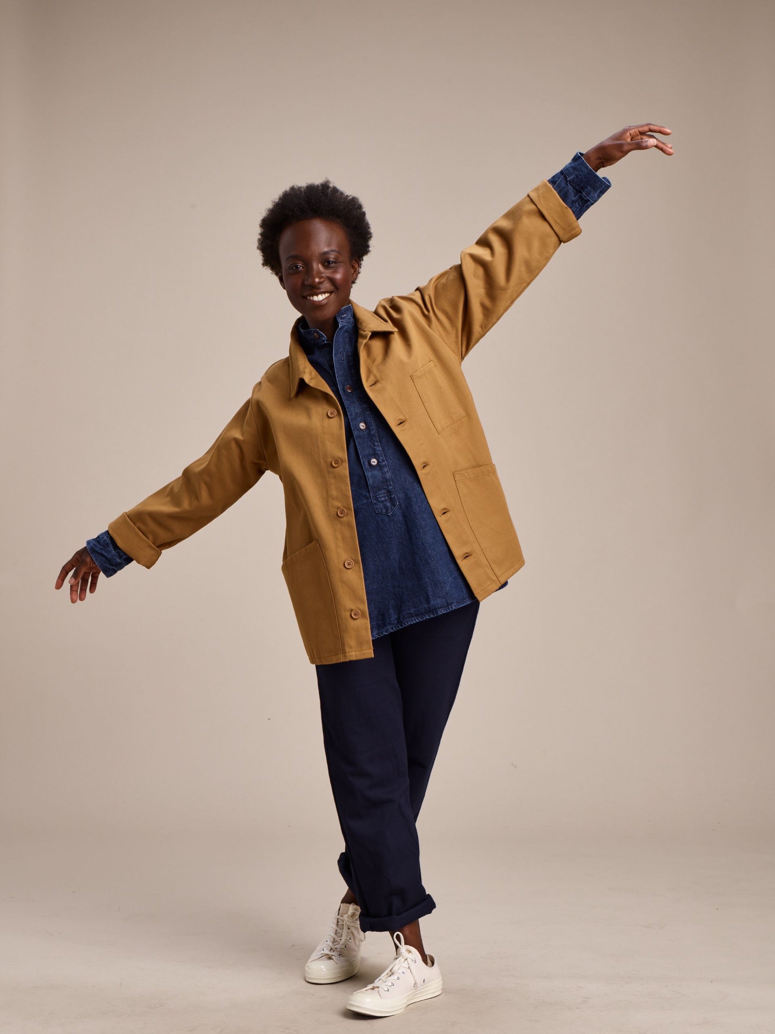 Woman wearing Carrier Company Work Jacket in Tan with Denim Work Shirt and Women's Work Trouser