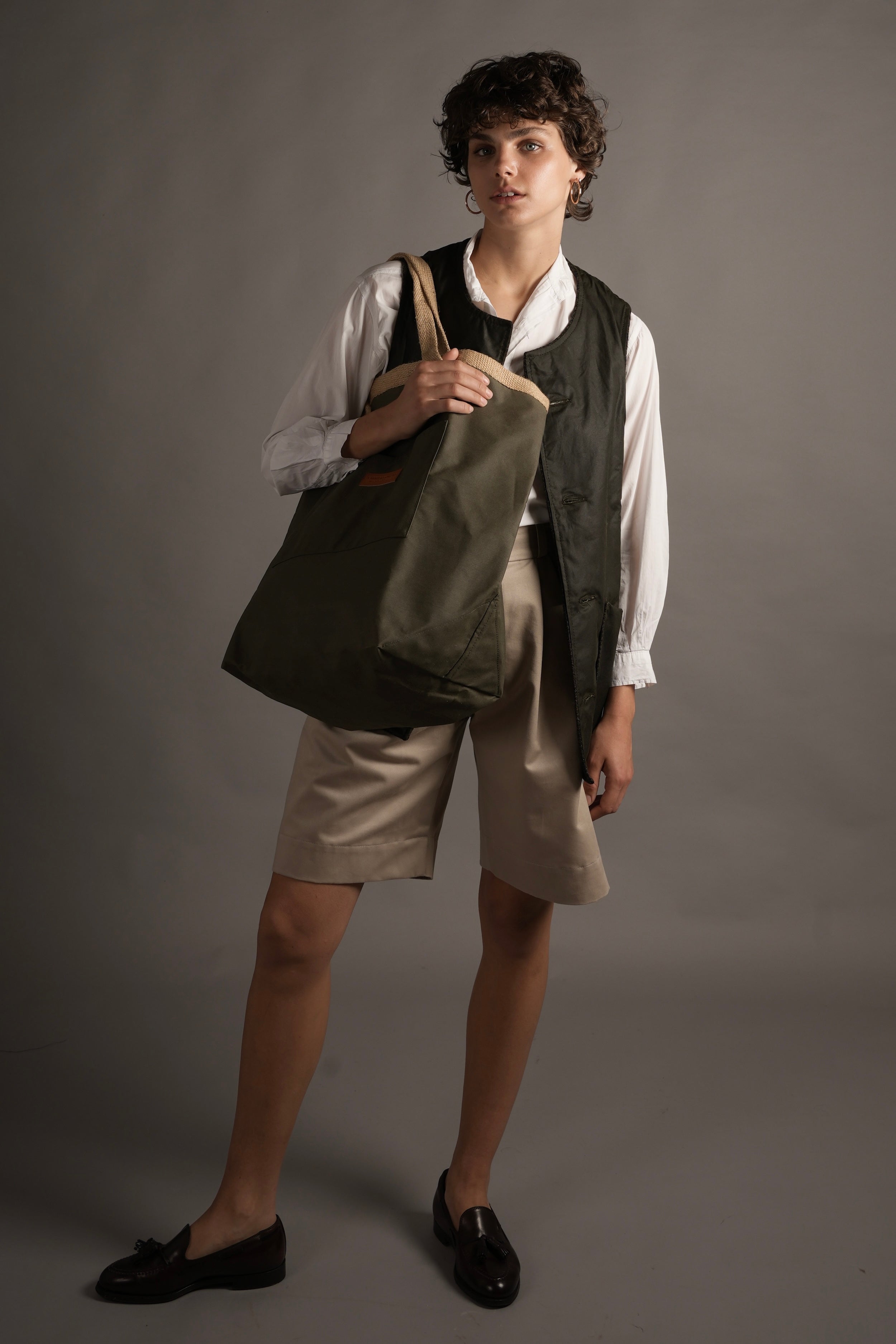 Woman holds Carrier Company Loot and Boot Bag in Olive