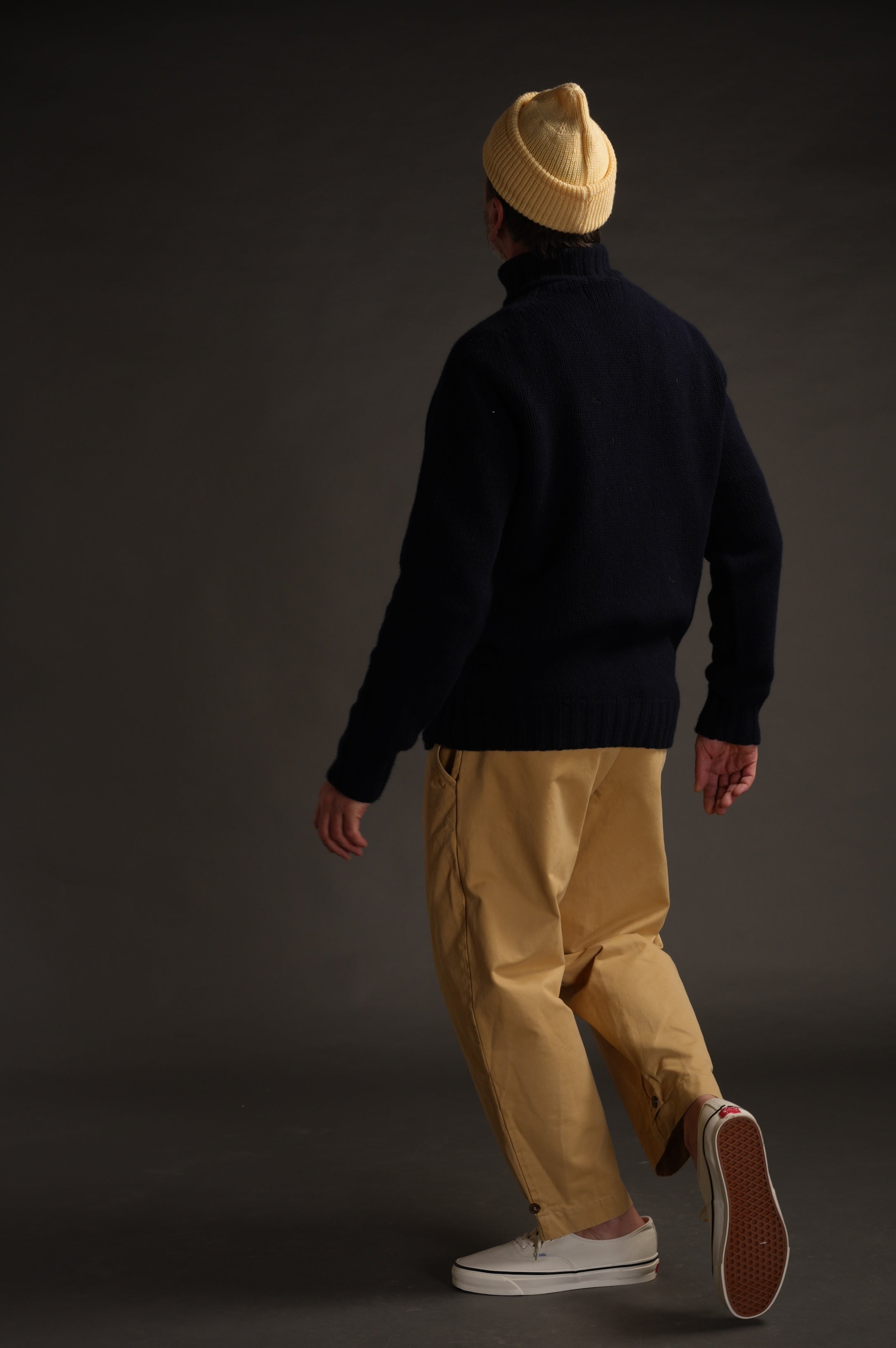 Enzo wears Navy Rollneck Supersoft Shetland jumper with Mortimer Trouser and Merino Watch Cap in Guava.