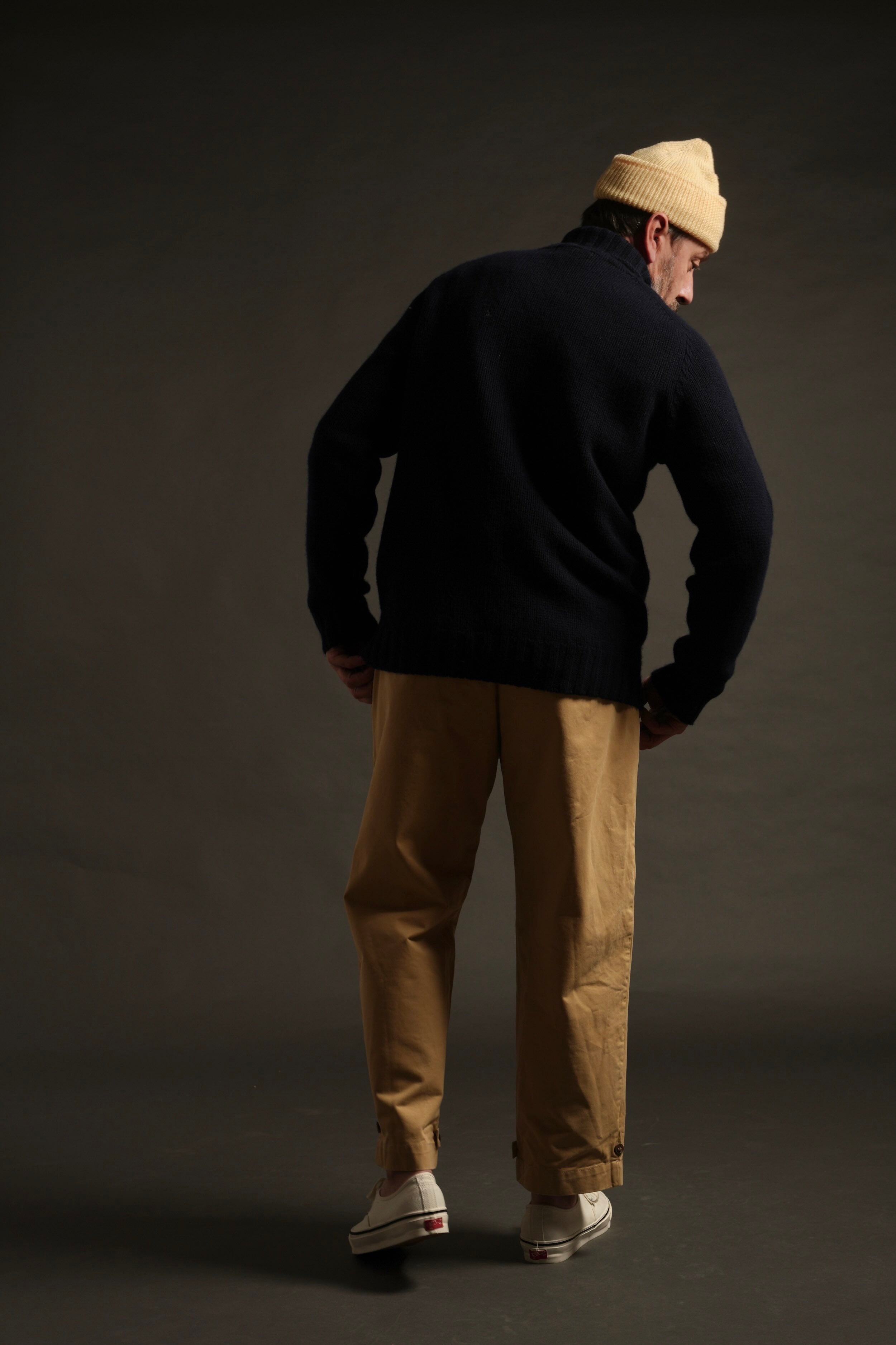 Enzo wears Navy Rollneck Supersoft Shetland jumper with Mortimer Trouser and Merino Watch Cap in Guava. Enzo is 6'1" and wears size XL