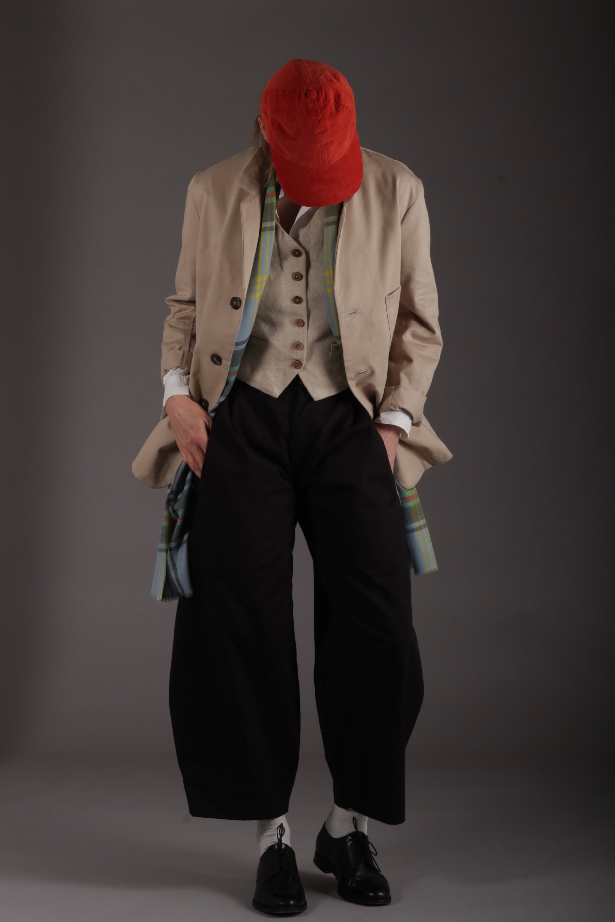 Sienna wears Carrier Company Dutch Trousers in Black Cotton Drill with Lightweight Collarless Shirt, Linene Waistcoat, Merino Scarf and Corduroy Baseball Cap