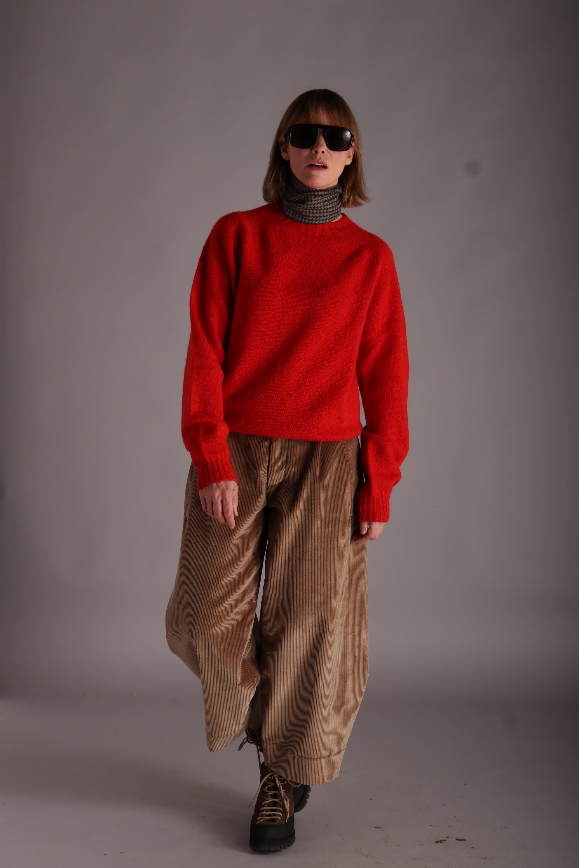 Sienna wears Carrier Company Shetland Lambswool Jersey in Scarlet with Dutch Trousers in Sand Corduroy