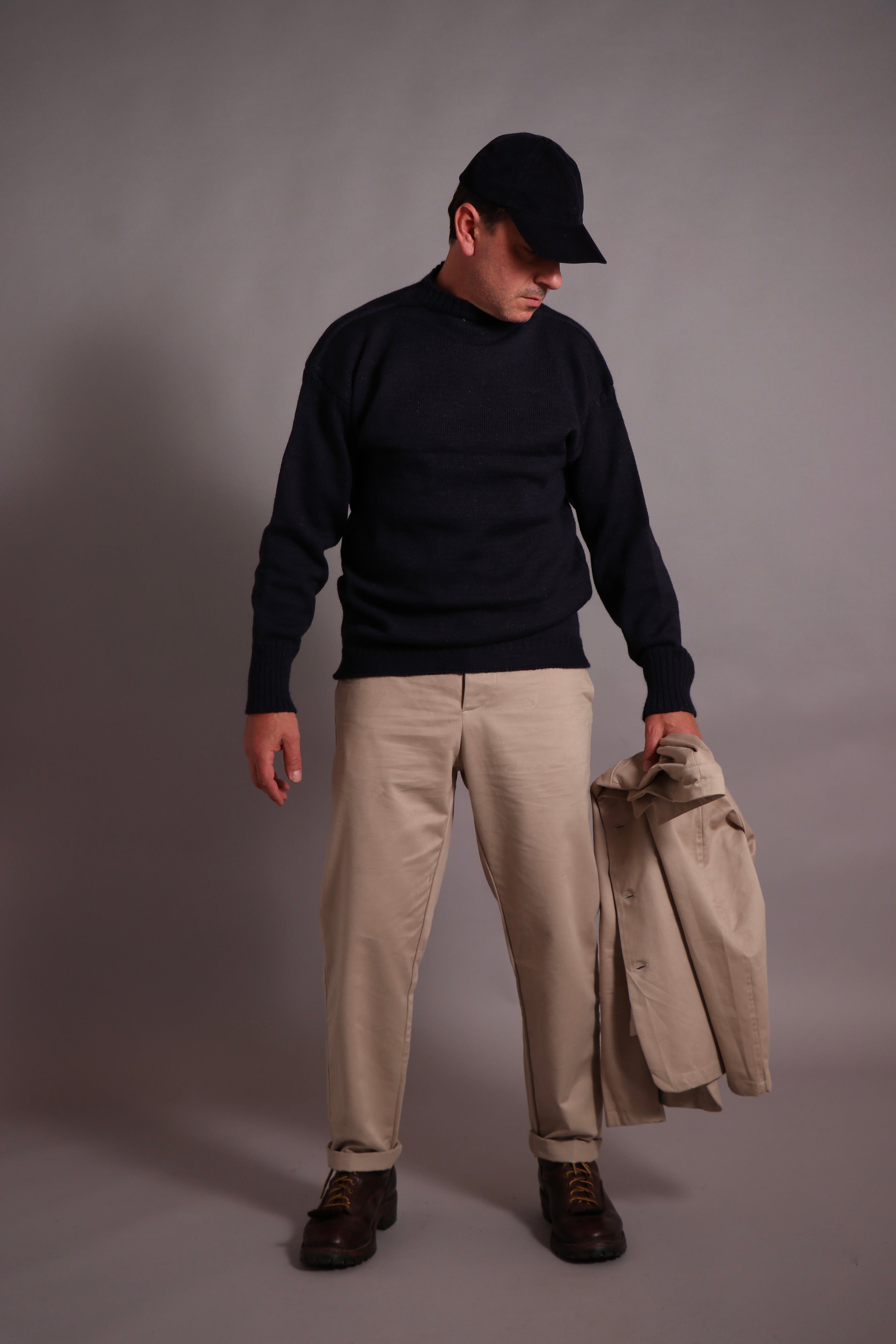 Enzo wears High Waist Trousers with Three Button Jacket and Le Tricoteur Guernsey