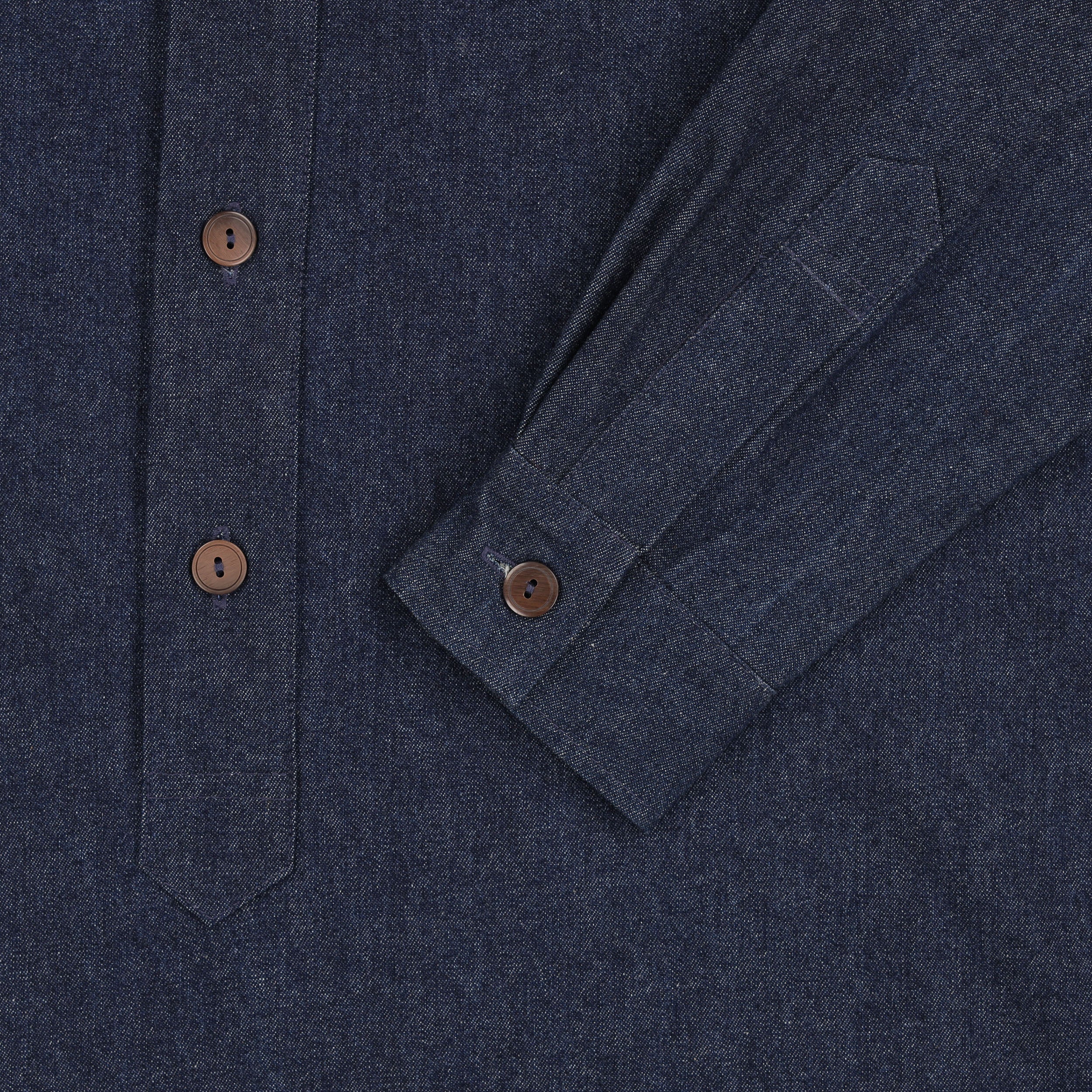 Close up of the button detail on the cuff and front of the Carrier Company Denim Work Shirt