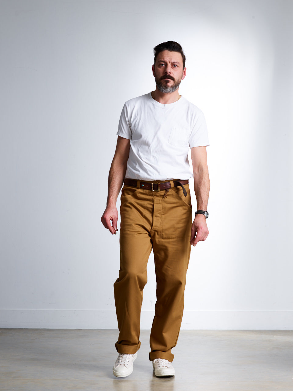 Man wearing Carrier Company Men's Work Trouser in Tan Drill