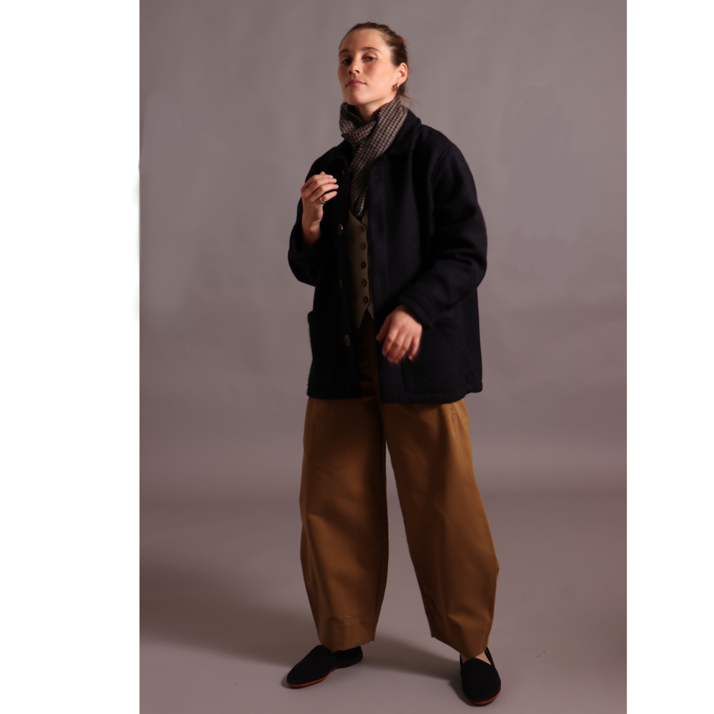 Decca wears Carrier Company Celtic Wool Jacket with Dutch trouser in Tan Cotton Drill, Wool Waistcoat and Scarf