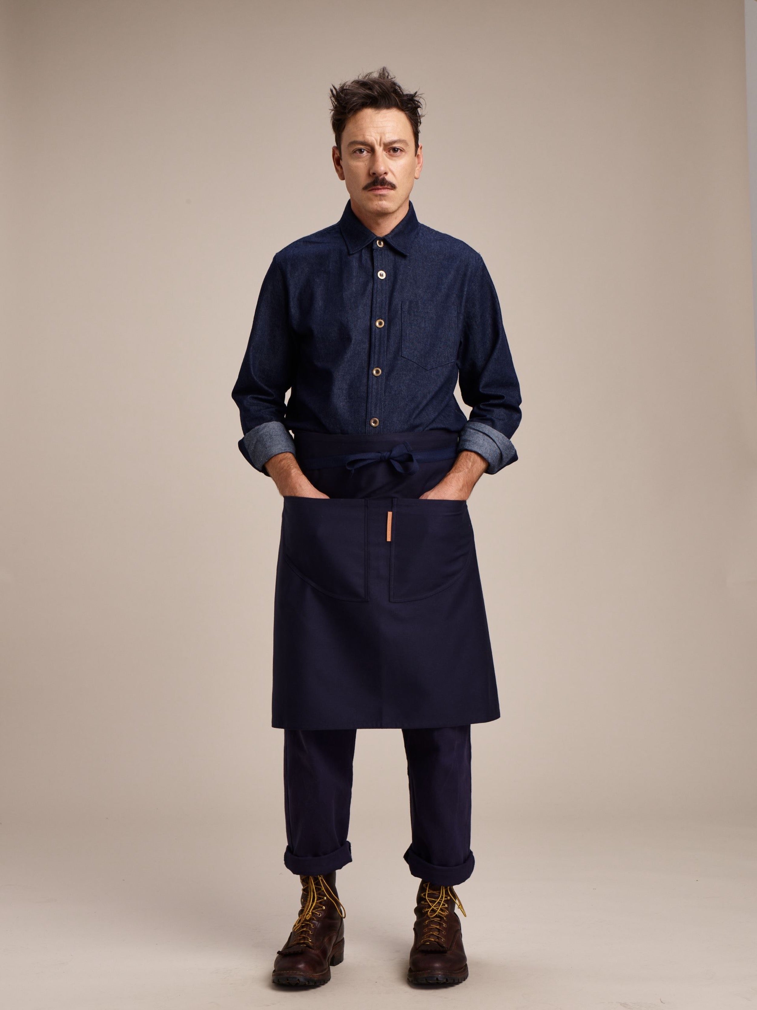 Man wearing Carrier Company Denim Collar Shirt, Chef's Apron and Men's Work Trouser