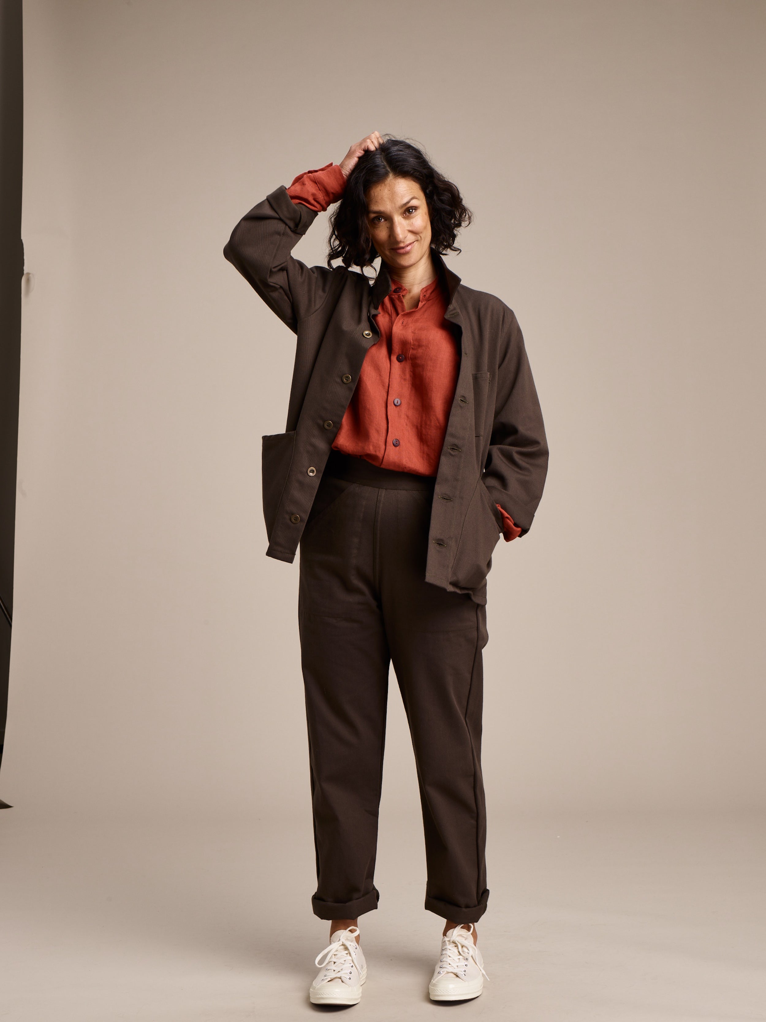 Woman wearing Carrier Company Women's Work Trouser in Olive with Norfolk Work Jacket and Linen Work Shirt