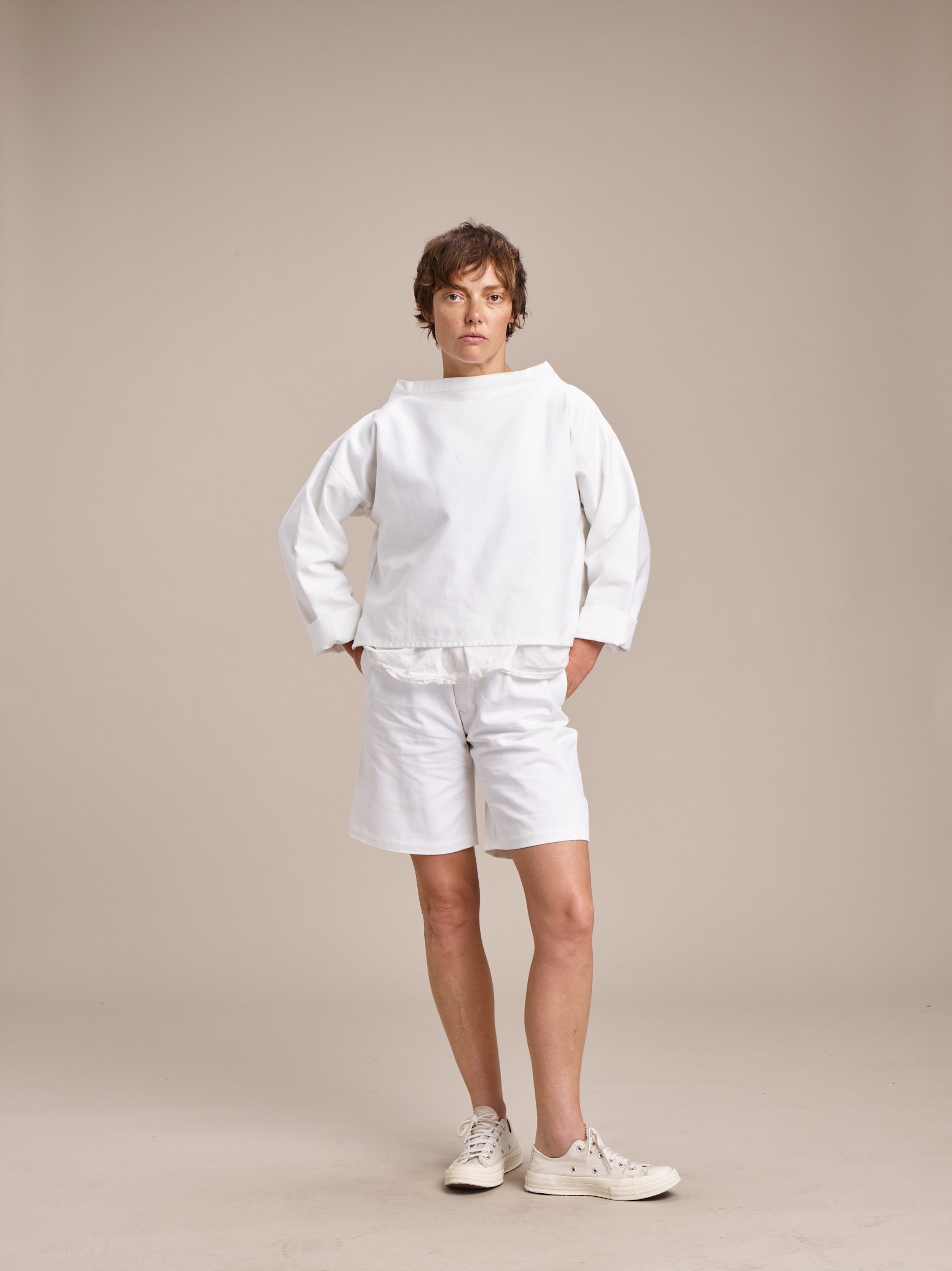 Woman wears Carrier Company Cropped Smock in White with Cotton Tee Shirt and Ladies Short in White