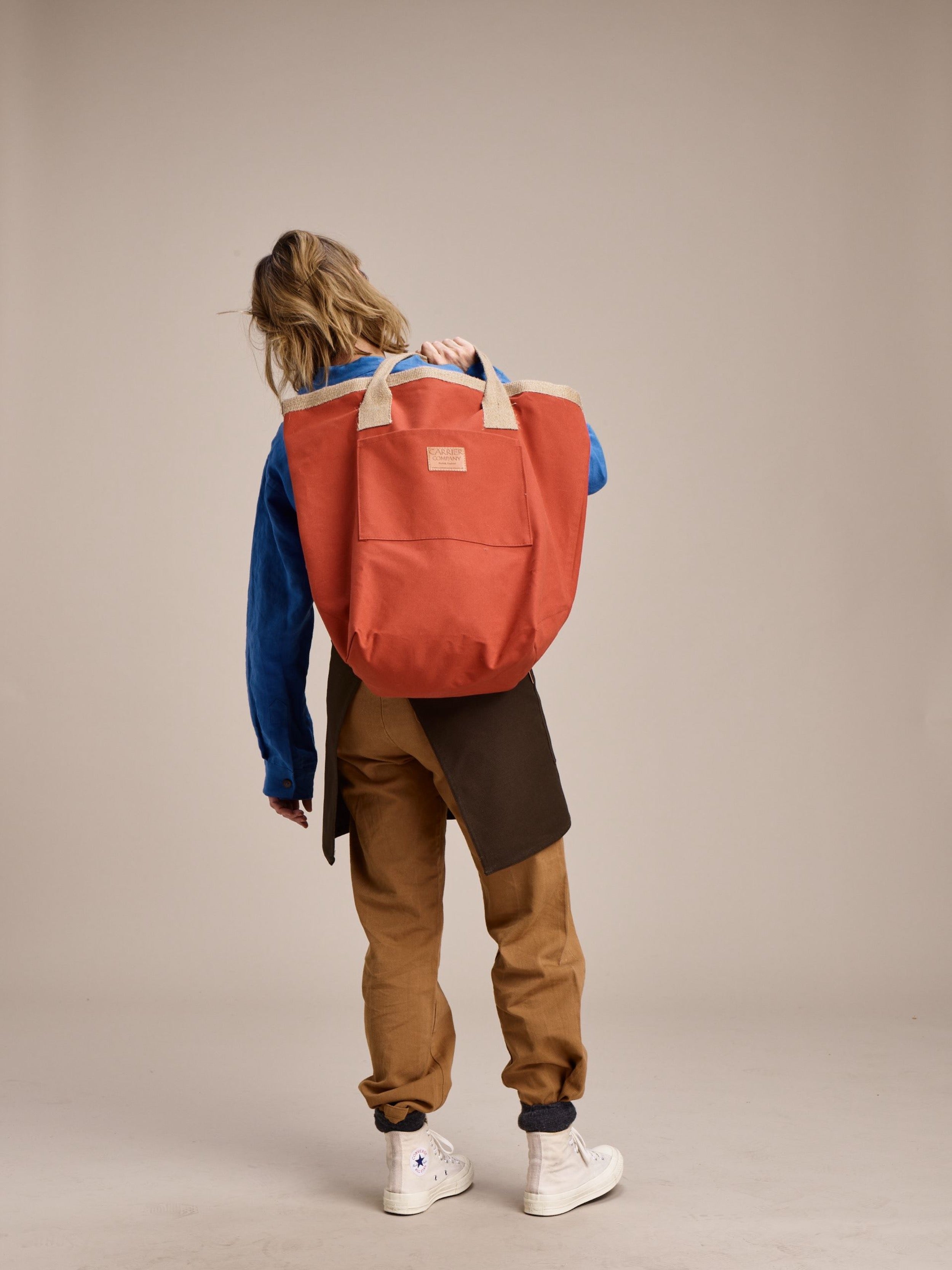 Woman holds Carrier Company Loot and Boot Bag in Orange