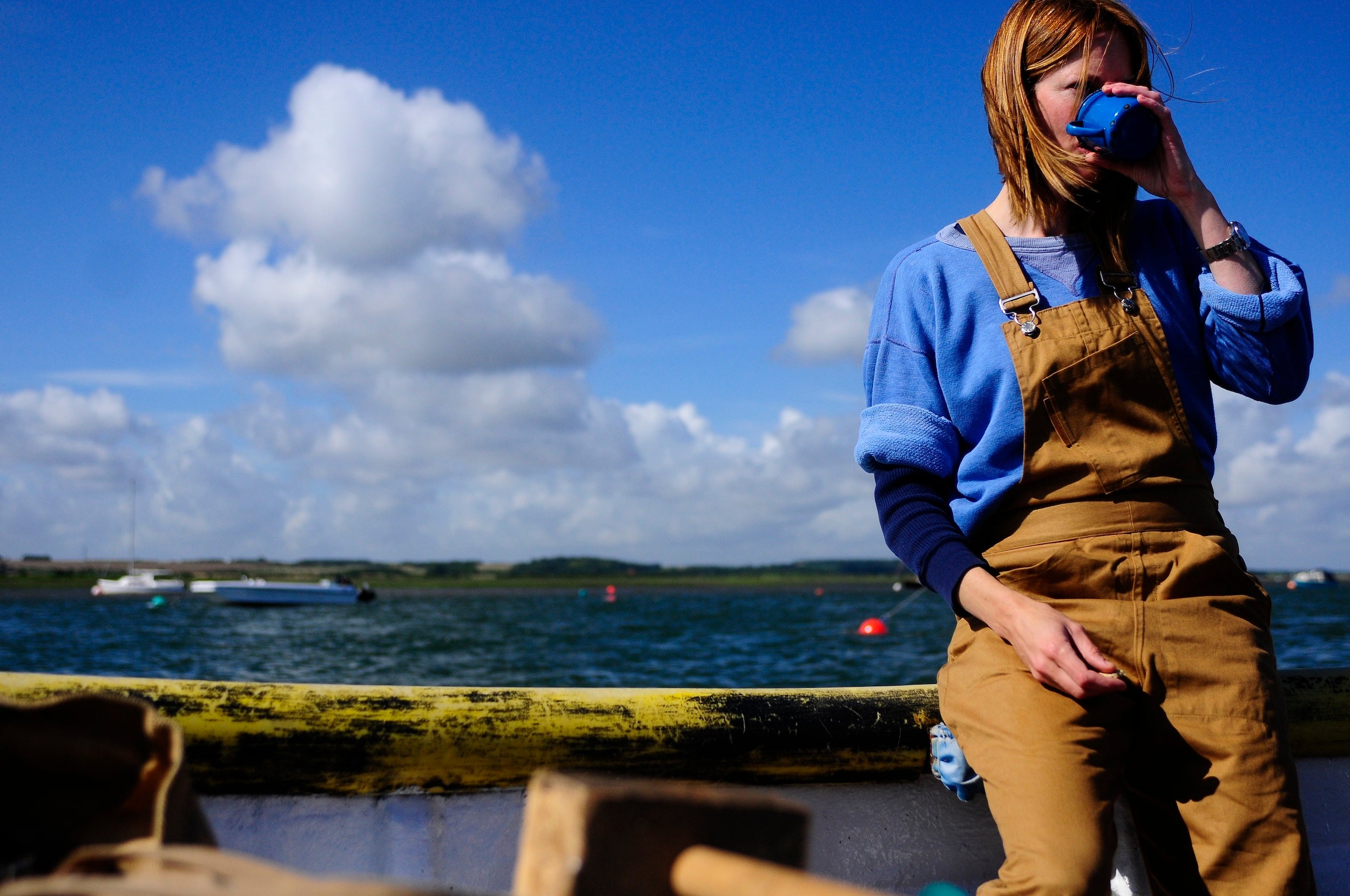 Woman wears Carrier Company Women's Dungarees in Tan