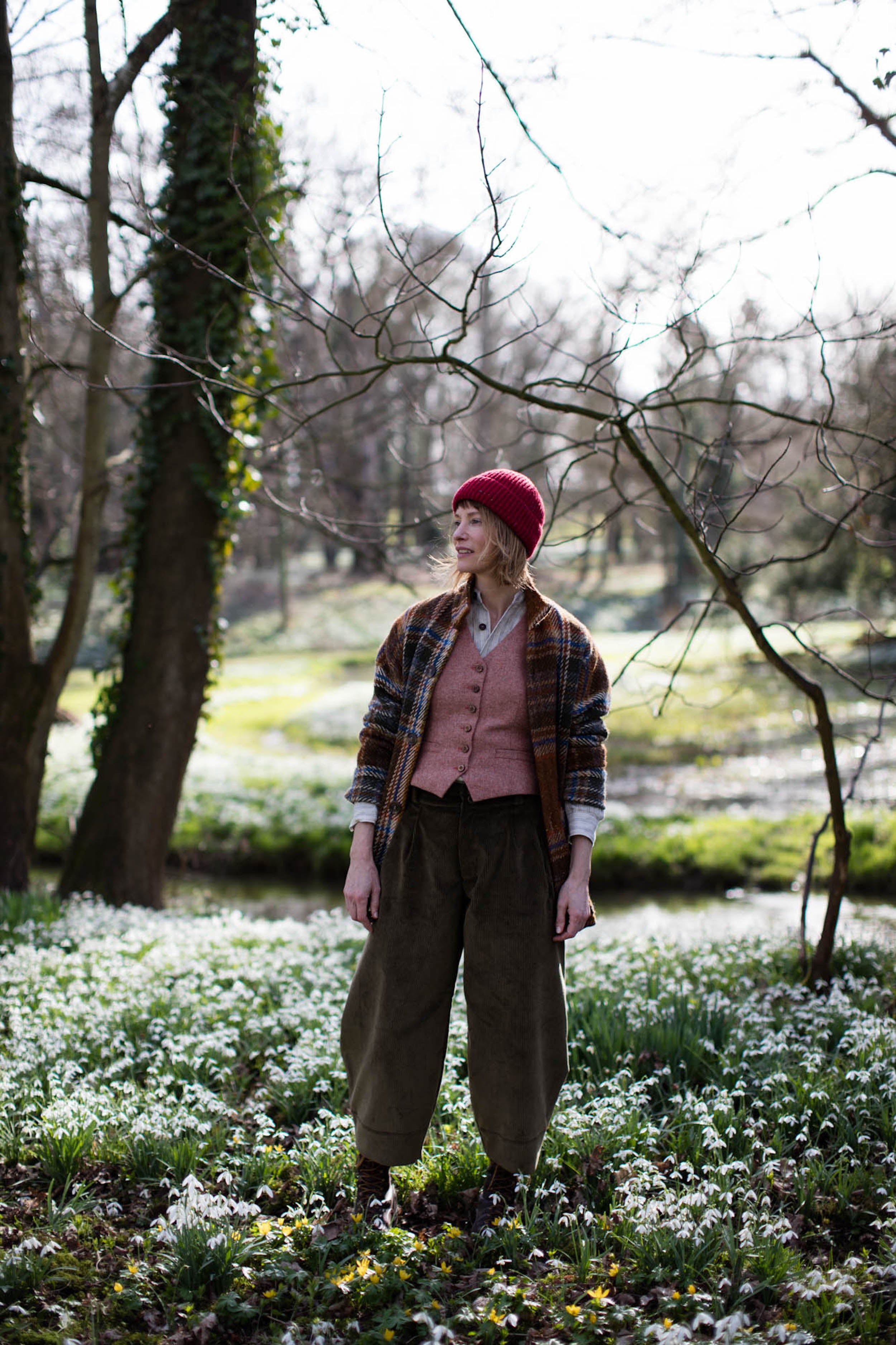 Woman wears Carrier Company Women's Wool Waistcoat in Coral with Celtic Wool jacket in Russet and Dutch Trouser in Corduroy