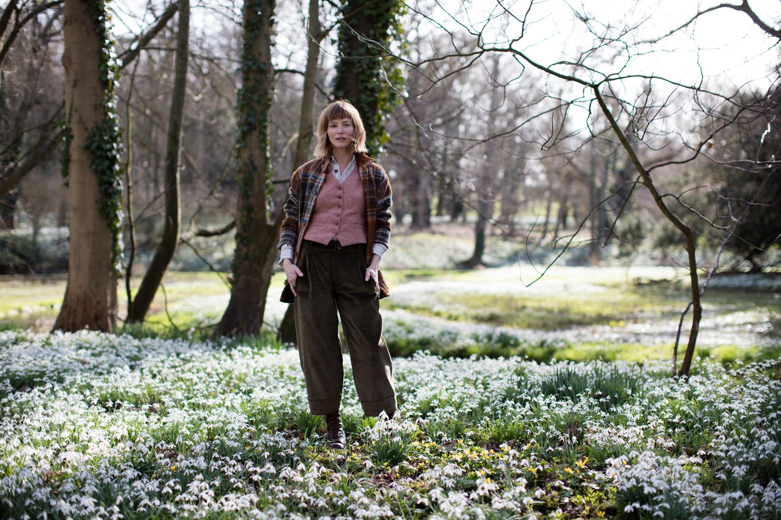 Woman wears Carrier Company Women's Wool Waistcoat in Coral with Celtic Wool jacket in Russet and Dutch Trouser in Corduroy