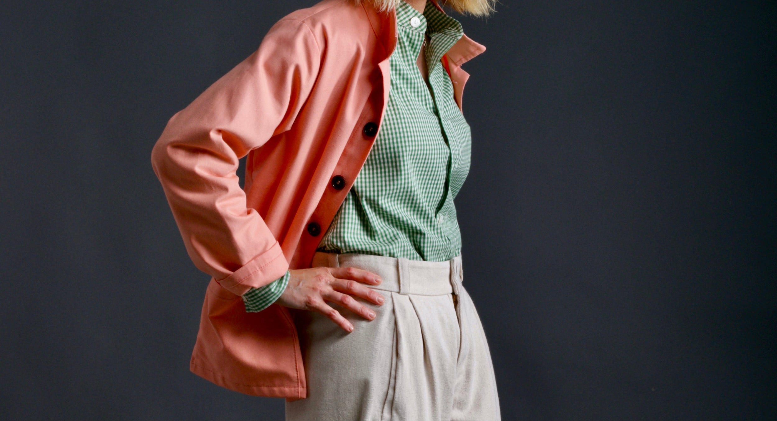 Woman wears Carrier Company Dutch Trouser in Seeded Denim with Gingham Work Shirt and Panama Sailcloth Work jacket in Cantaloupe