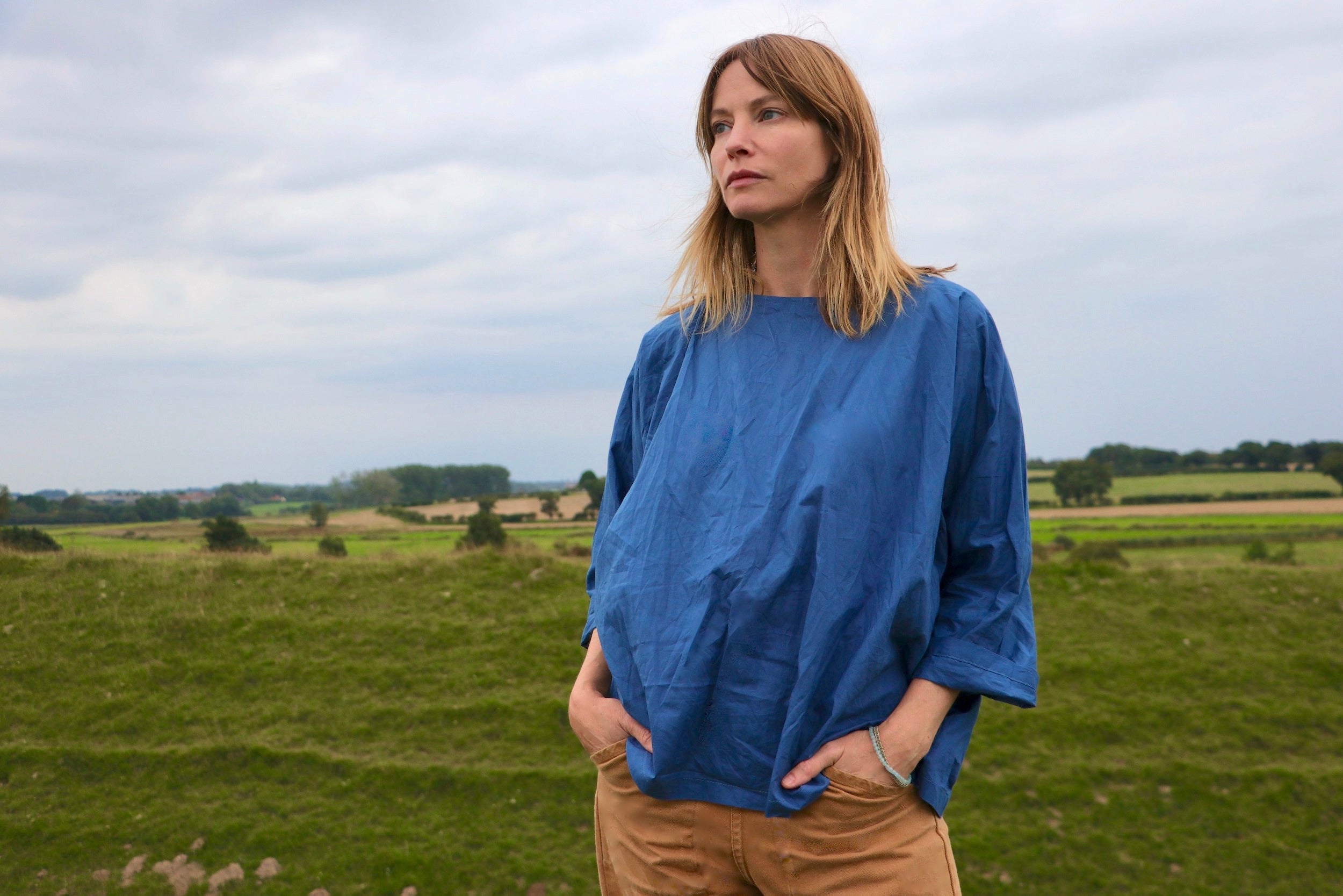 Woman wears Carrier Company Cotton Tee Shirt in Petrol Blue