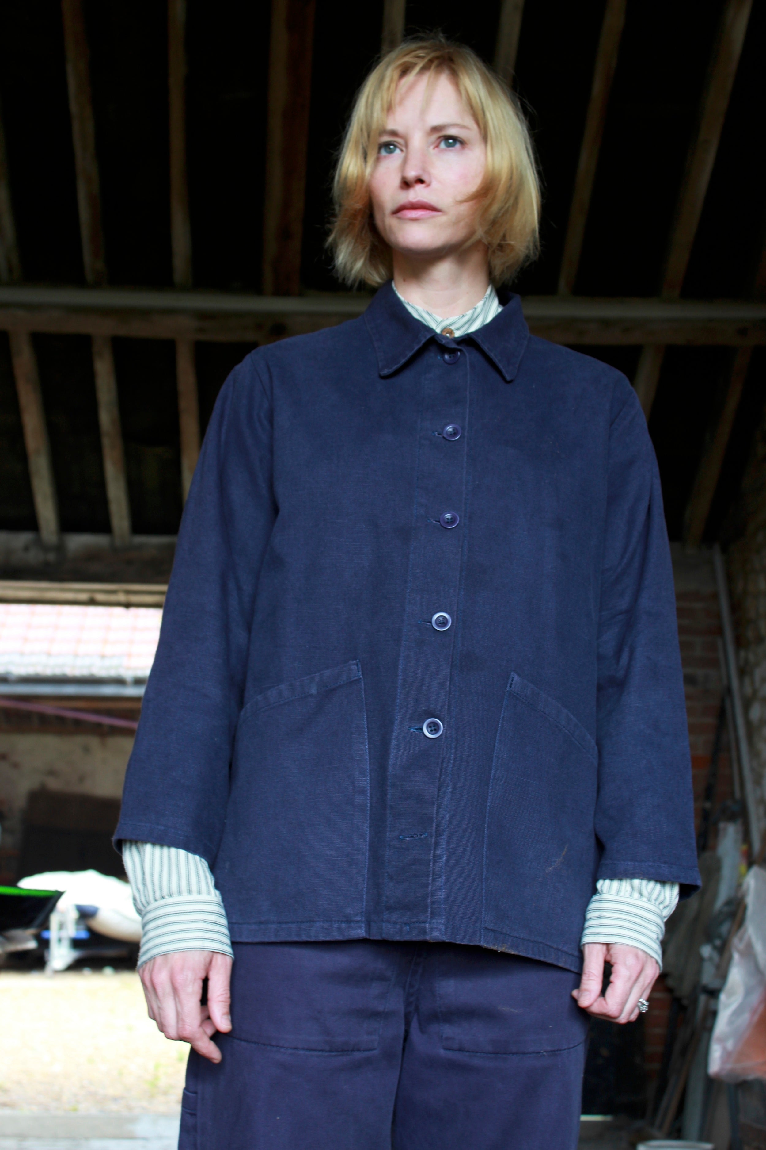 Woman wearing Carrier Company Traditional Norfolk Work Jacket in Navy and Collarless Work Shirt