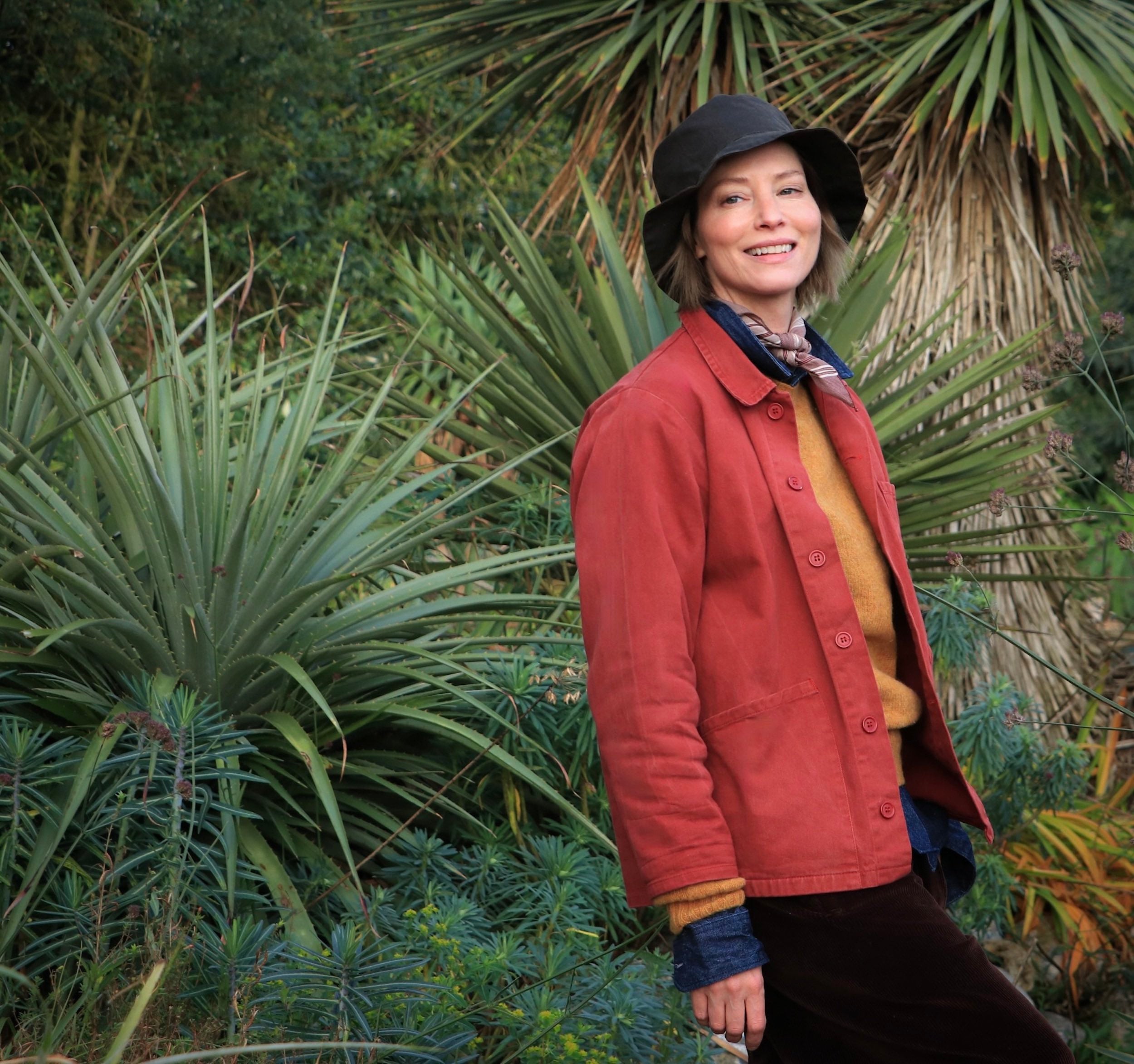 Sienna wears Carrier Company Norfolk Work Jacket in Orange, Denim Collar Shirt, Shetland Lambswool Jumper in Cumin and Dutch Trouser in Corduroy