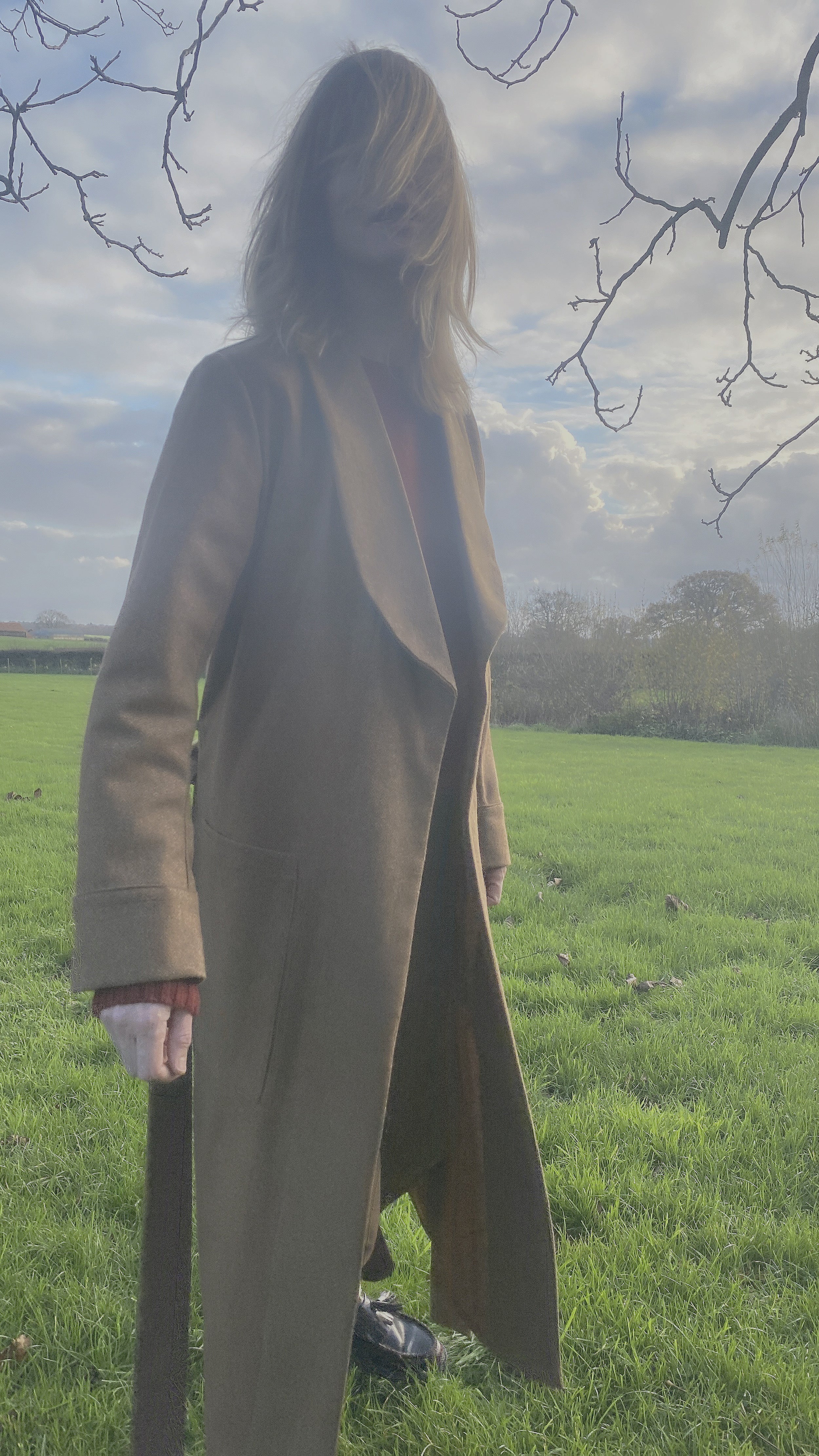 Woman wearing Carrier Company Wool Dressing Gown in Tan Herringbone and Shetland Lambswool Jumper in Blaze