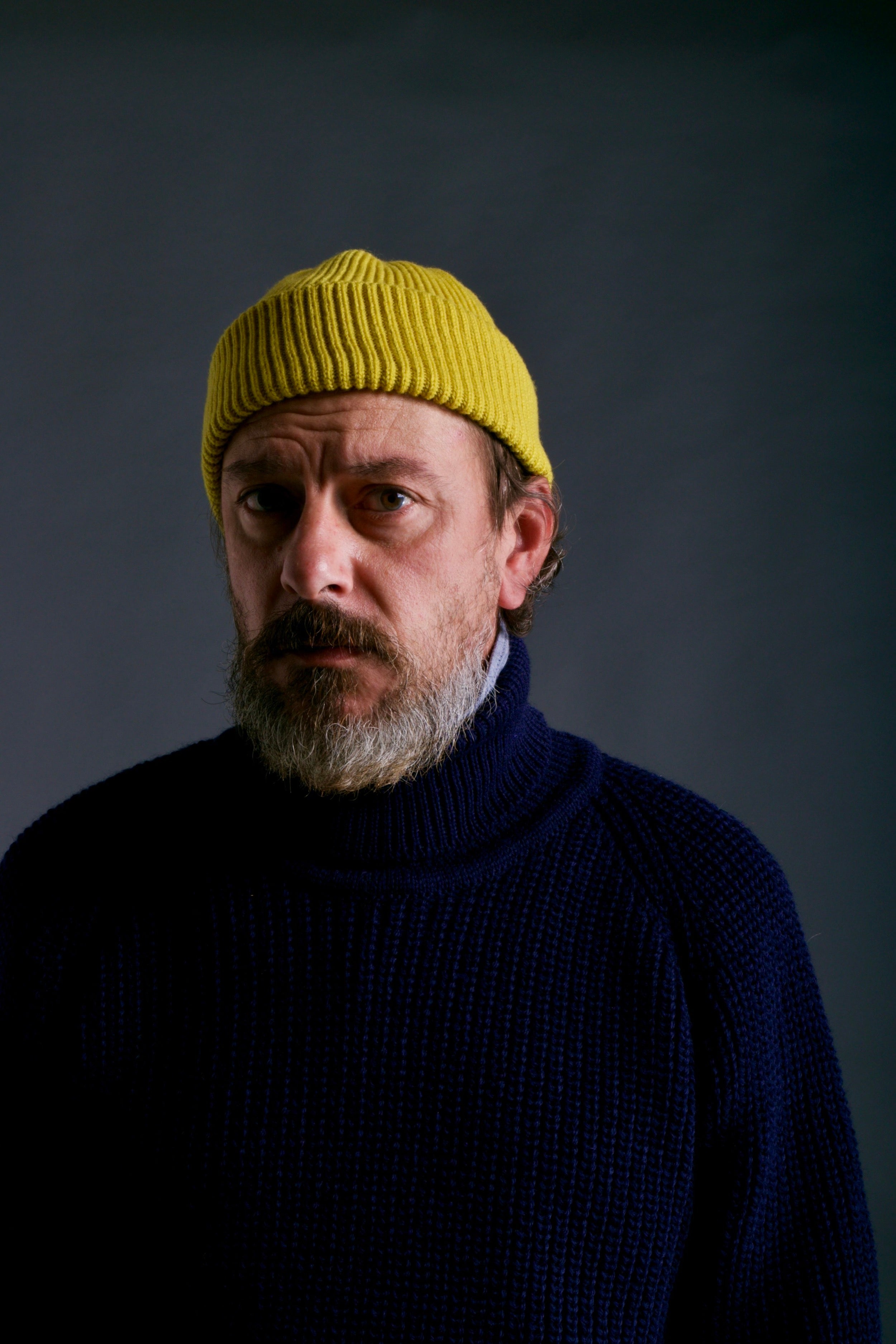 Man wears Carrier Company Yellow Wool Hat and Fisherman's Jumper