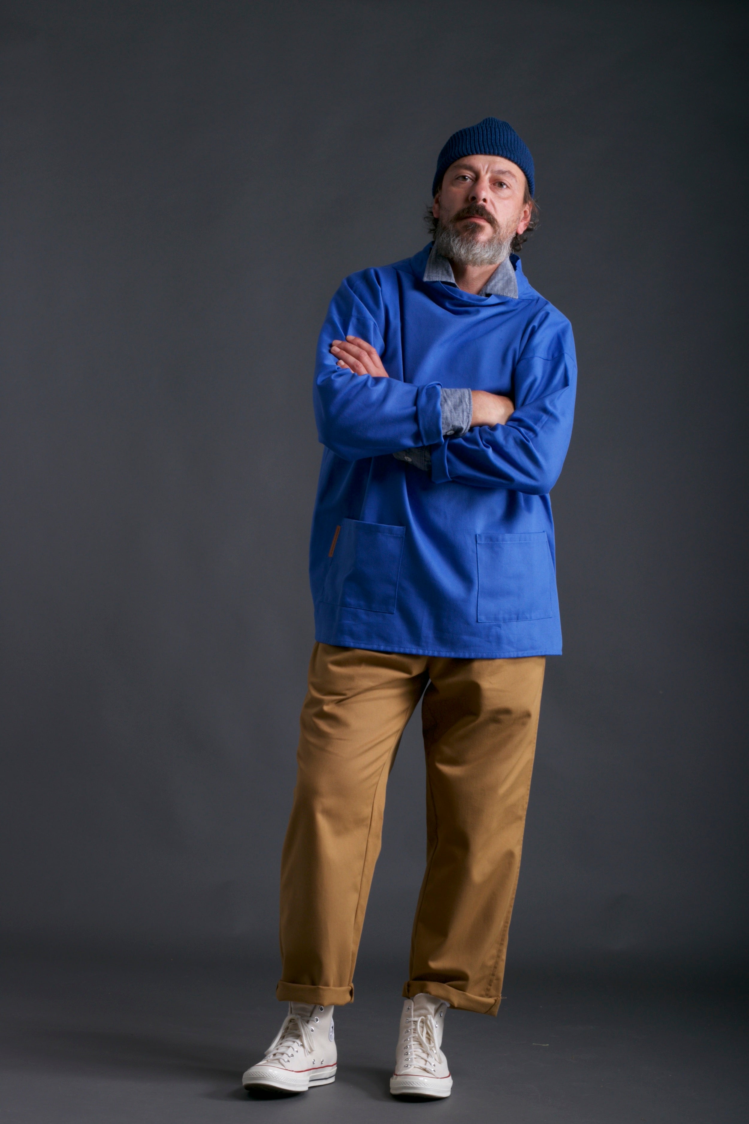 Man wears Carrier Company Traditional Norfolk Slop in Sky Blue with classic Trouser, Chambray Shirt and Wool Hat in Petrol Blue