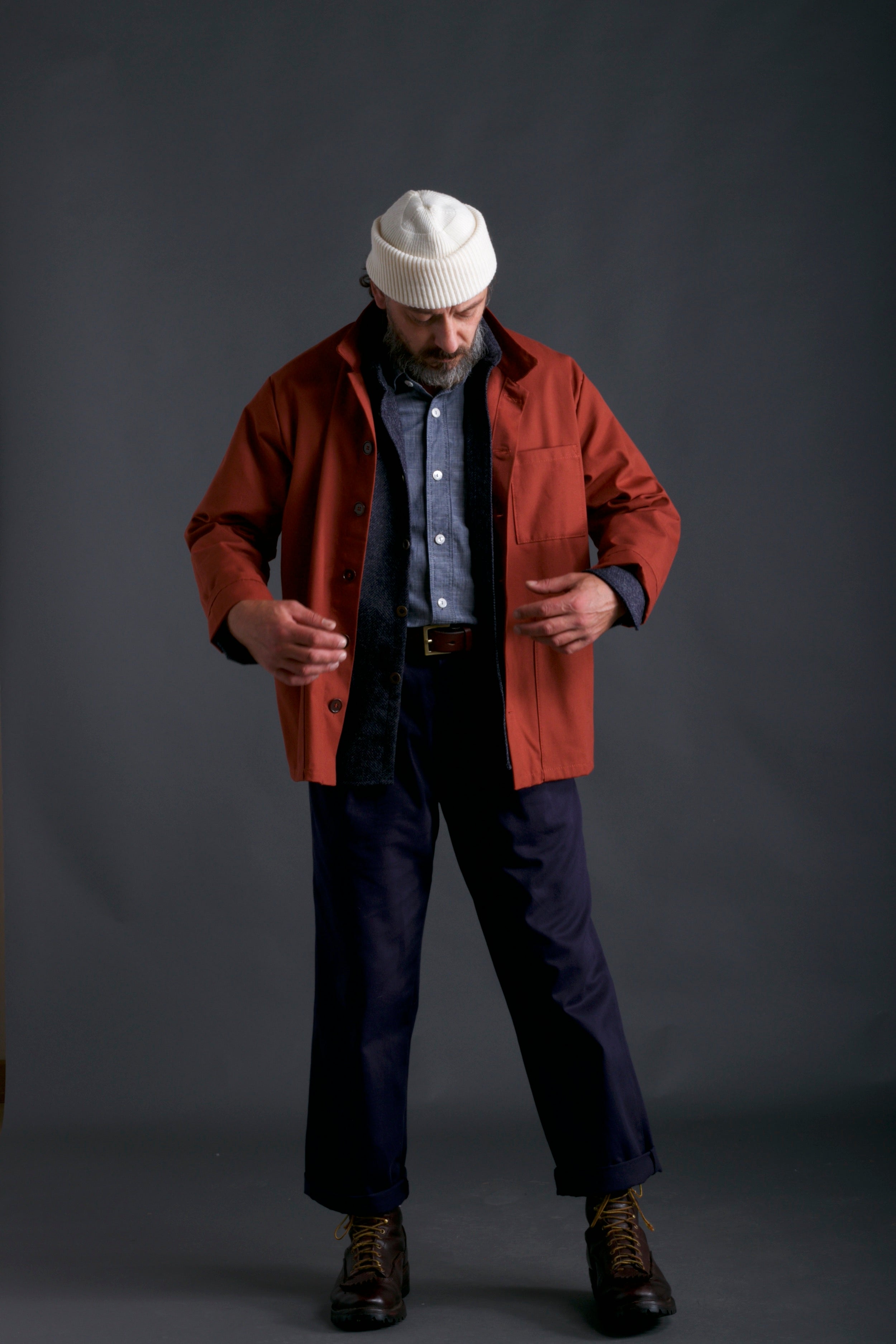 Man wears Carrier Company Chambray Shirt, Classic Trouser in Navy, Wool Collar Shirt, Breton Work Jacket and Wool Hat