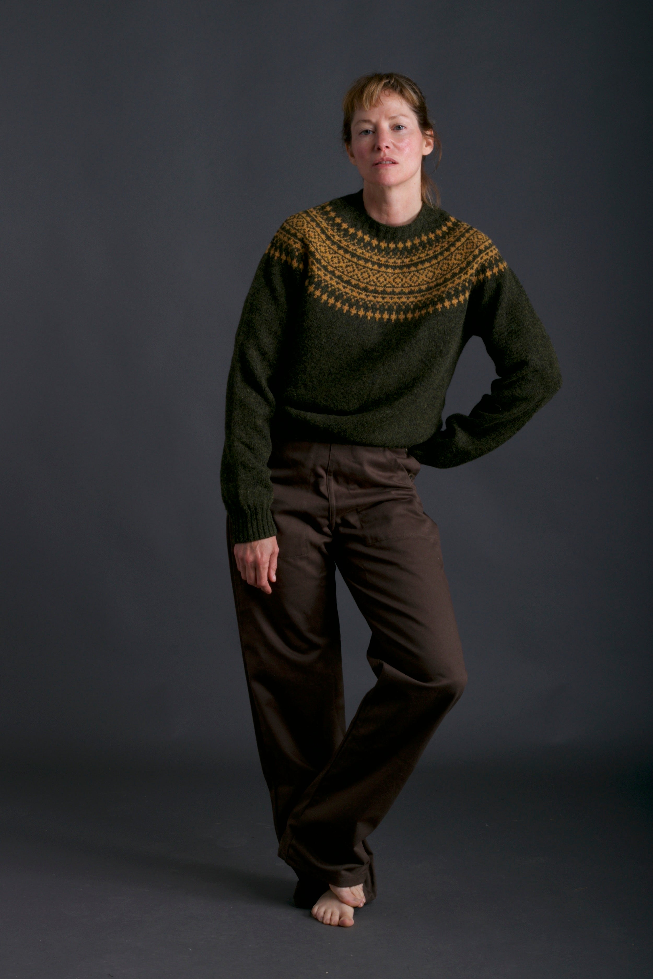 Woman wears Carrier Company Shetland Lambswool with Yoke and Olive Work Trouser
