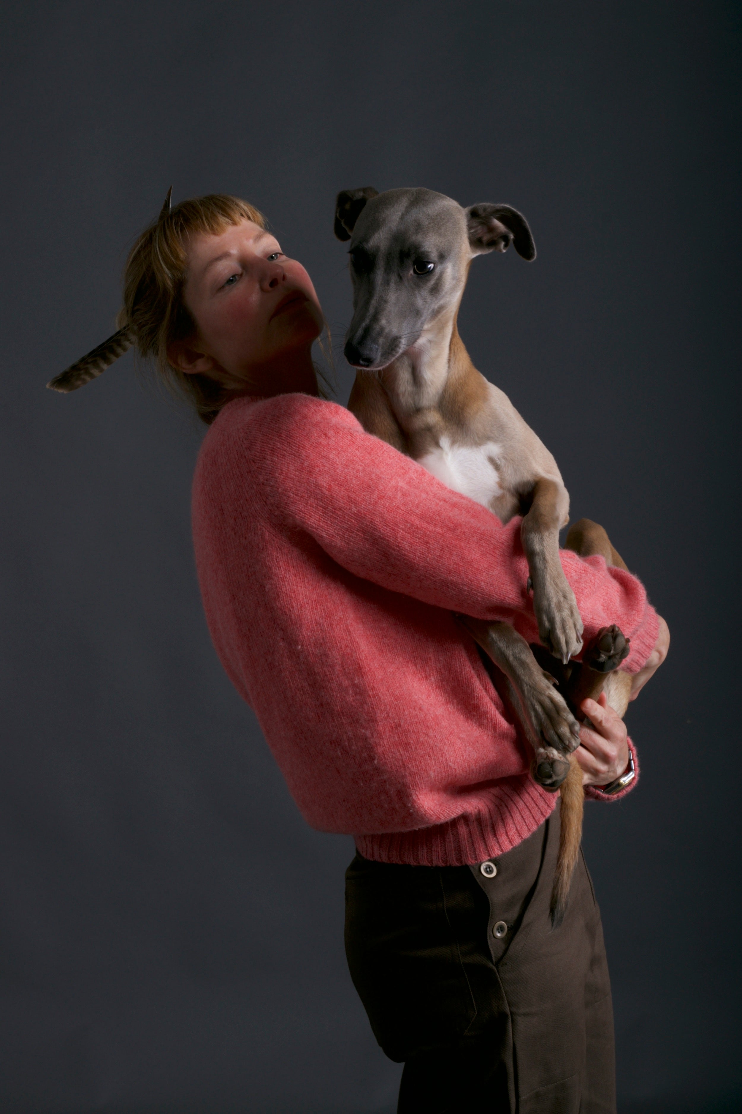 Woman wears Carrier Company Shetland Lambswool Jumper in Salmon