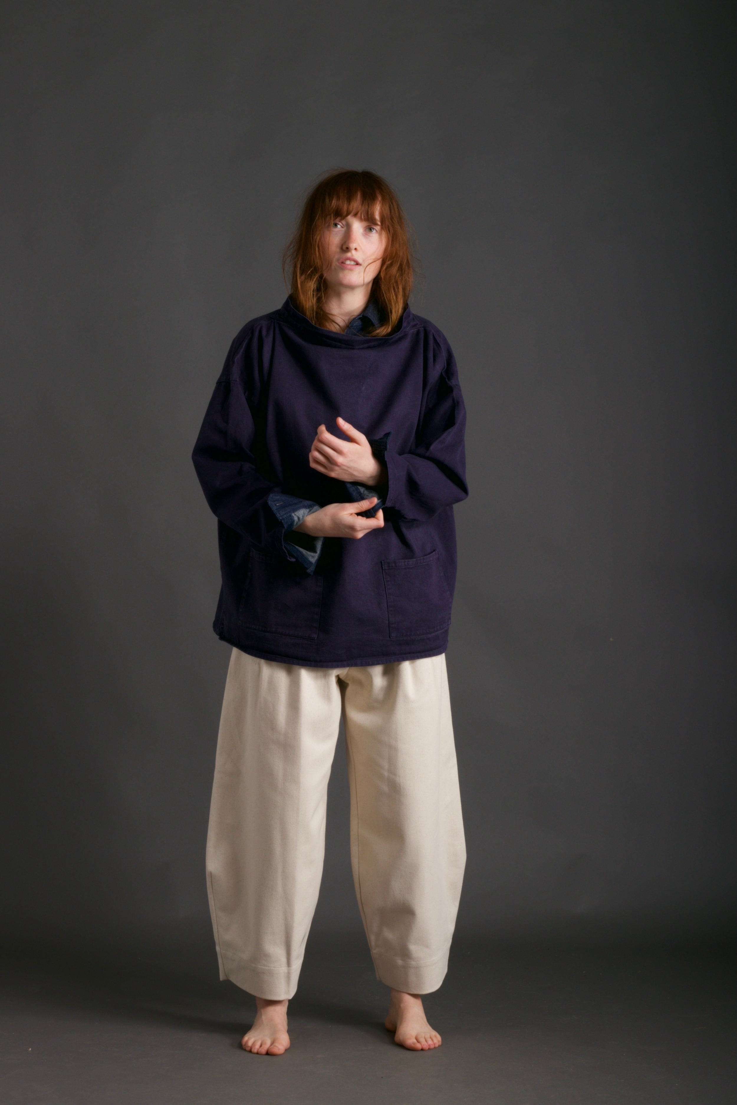 Woman wears Dutch Trouser in Seeded Denim, with Traditional Norfolk Slop in Navy