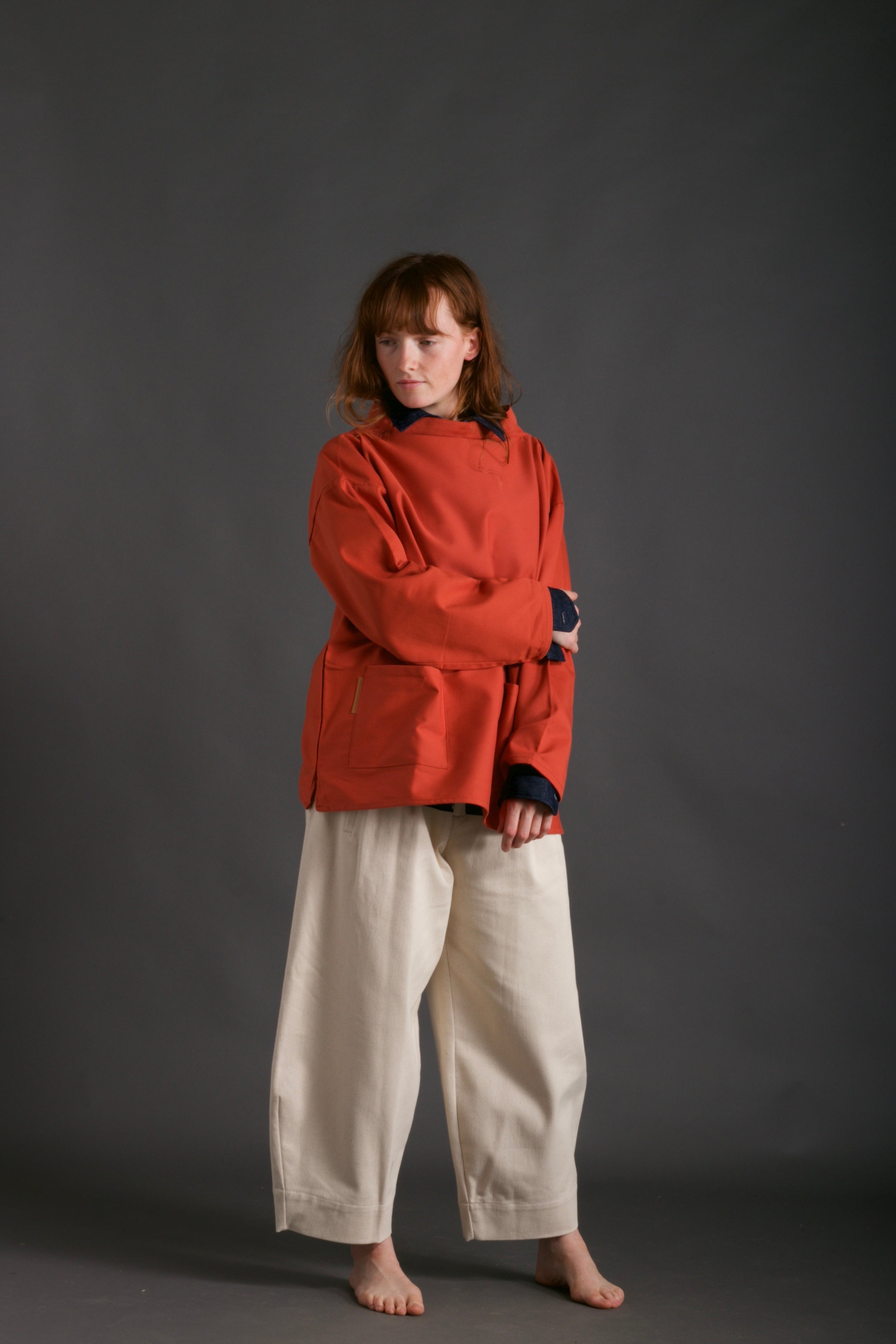Woman wears Carrier Company Traditional Norfolk Slop in Orange and Dutch Trouser in Seeded Denim