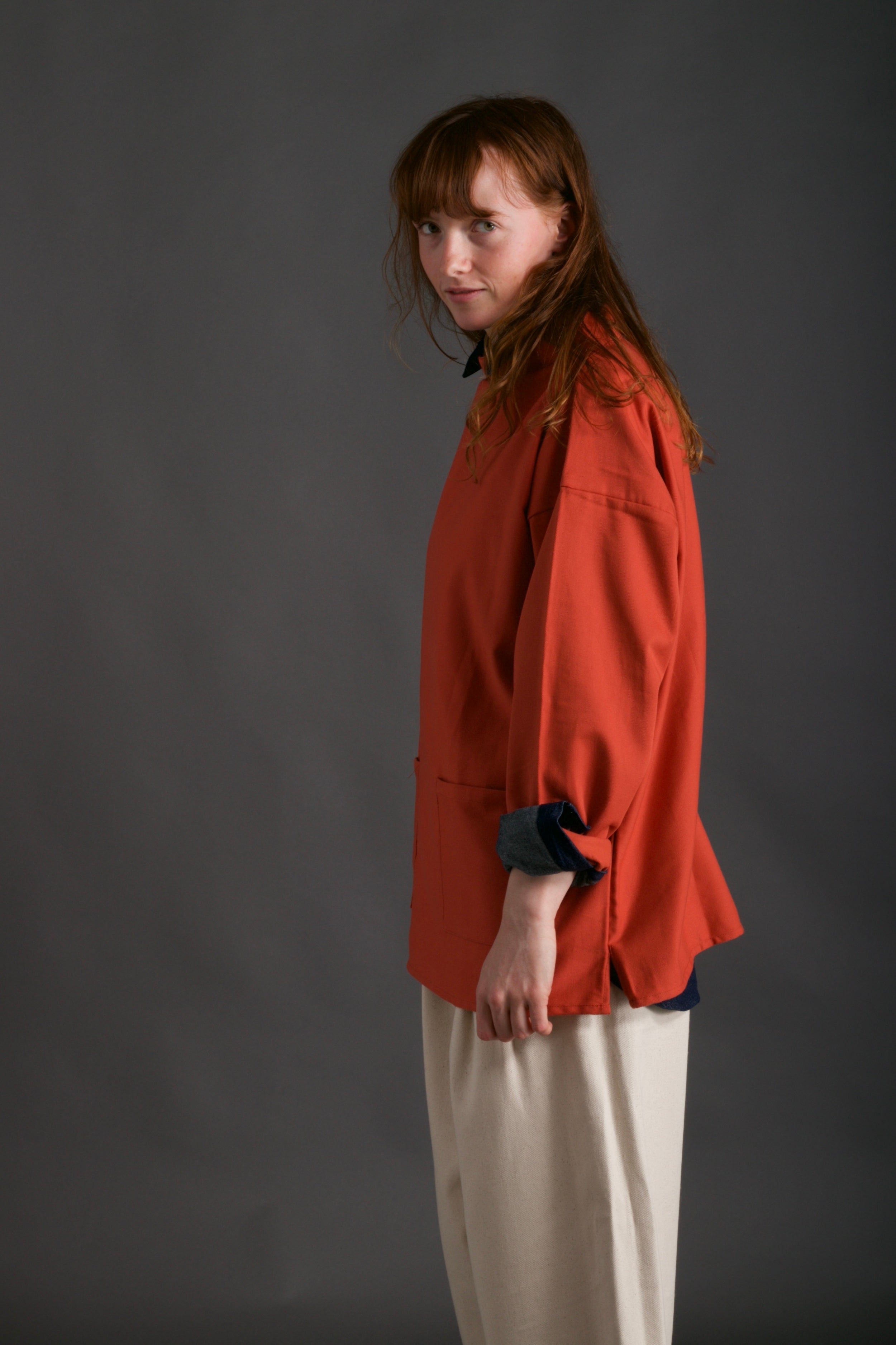 Woman wears Carrier Company Traditional Norfolk Slop in Orange and Dutch Trouser in Seeded Denim