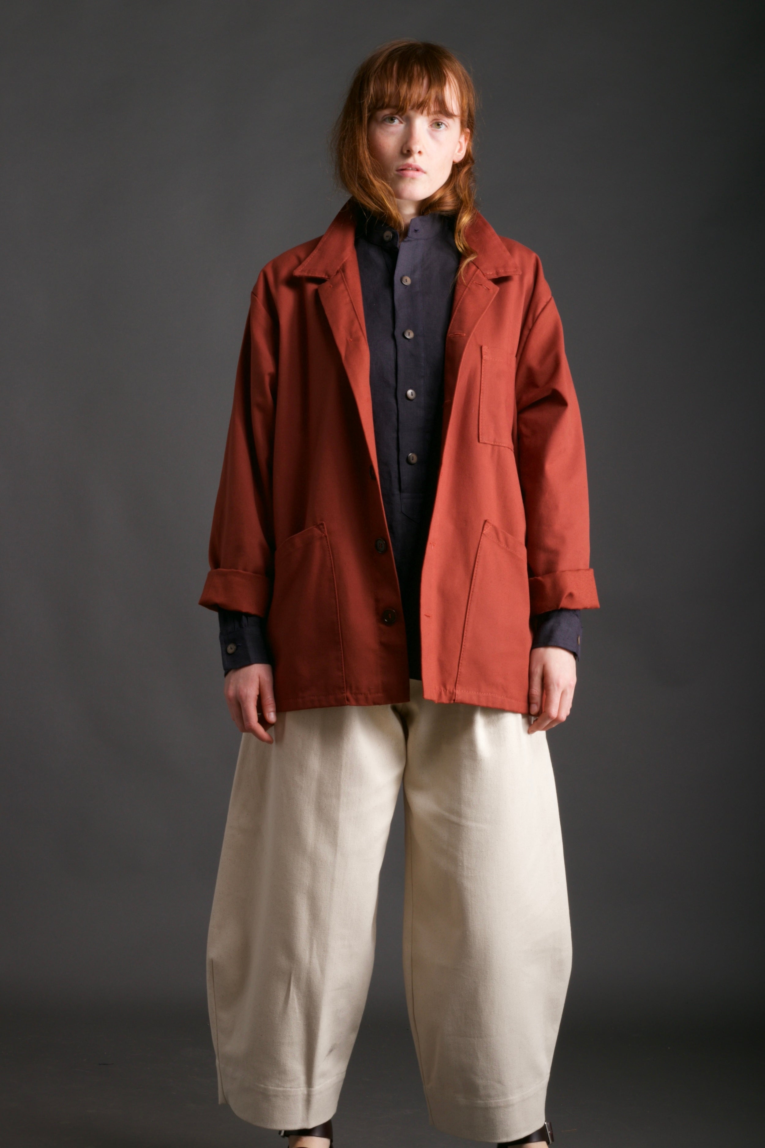 Woman wears Norfolk Work Jacket in Breton with Navy Linen Collarless Shirt and Dutch Trouser in Seeded Denim