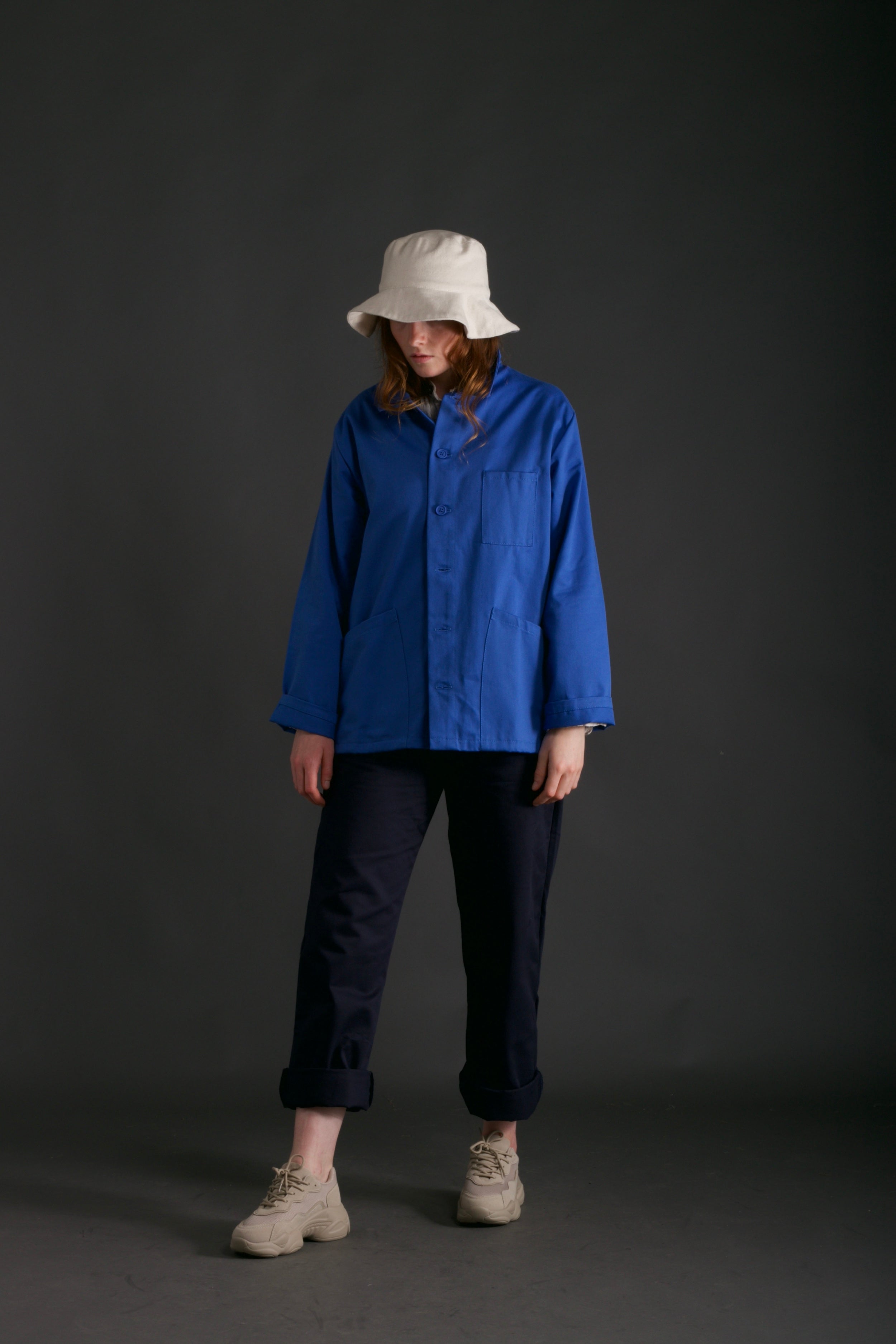 Woman wears Carrier Company Traditional Work Jacket in Sky Blue
