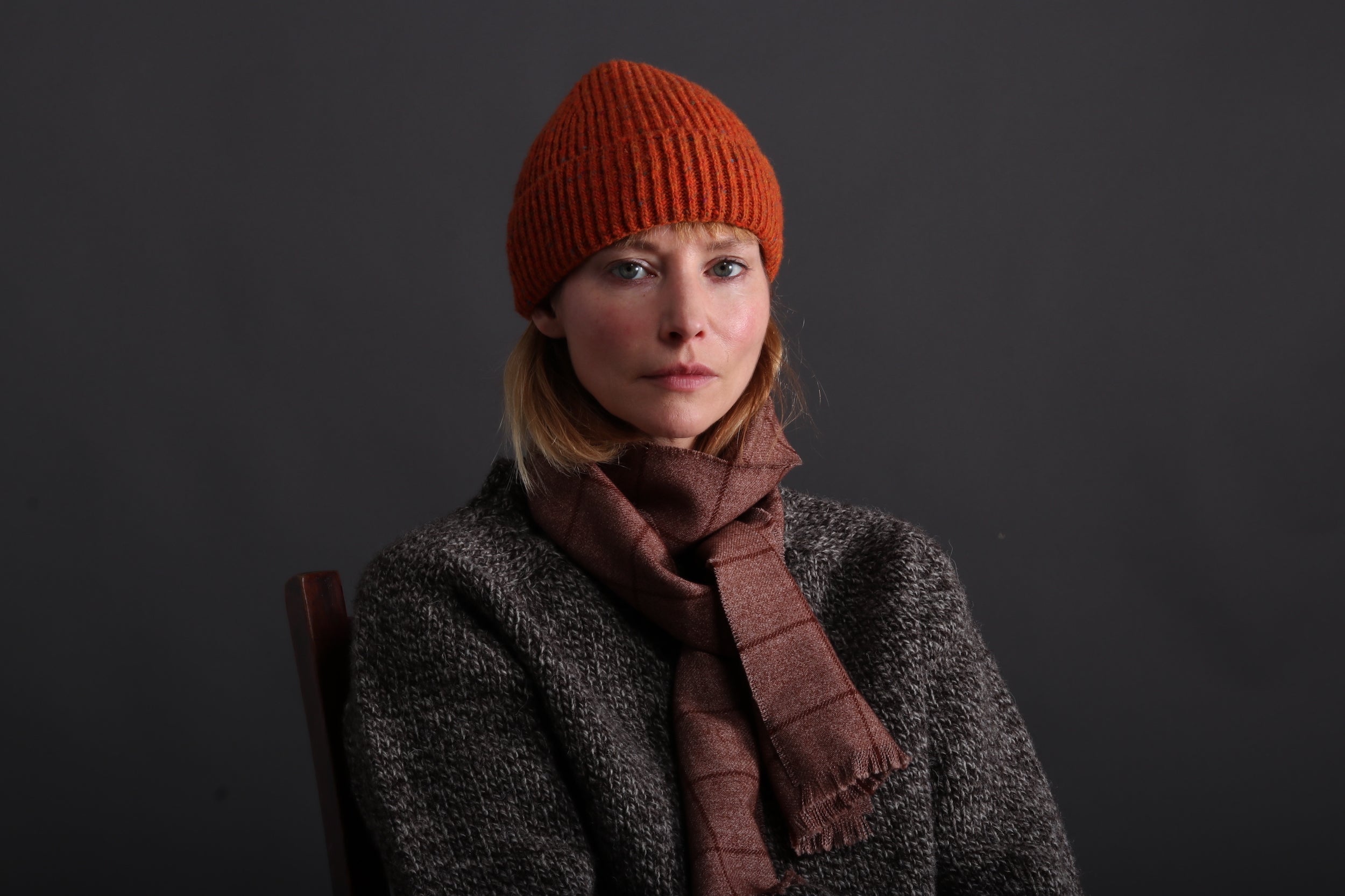 Woman wearing Tangerine Donegal Wool Hat with Heavy Heritage Lambswool Jumper and Check Short Scarf