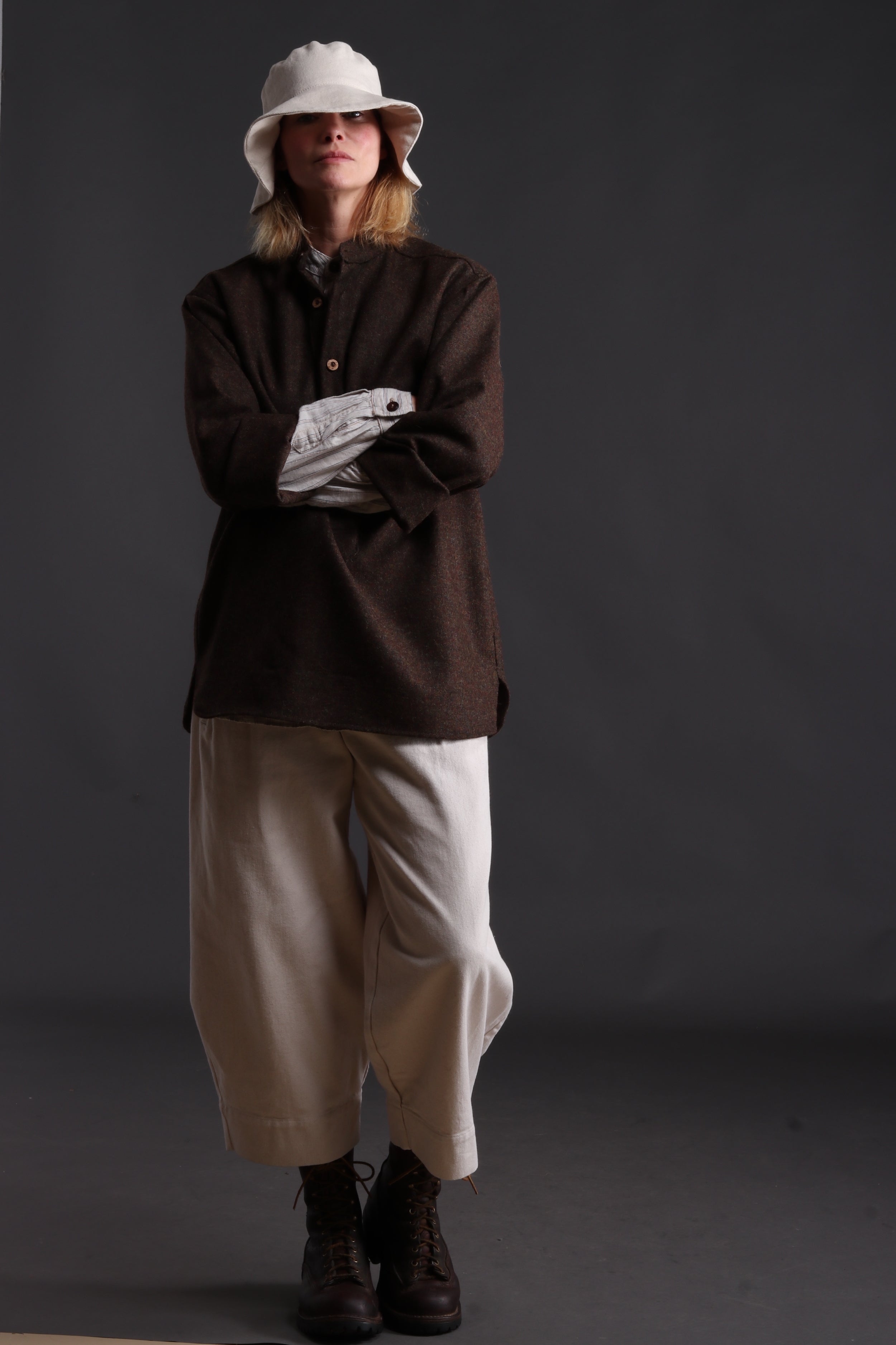 Woman wears Carrier Company Overshirt with Striped Linen Collarless Shirt, Dutch Trouser in Seeded Denim and Cotton Sun Hat