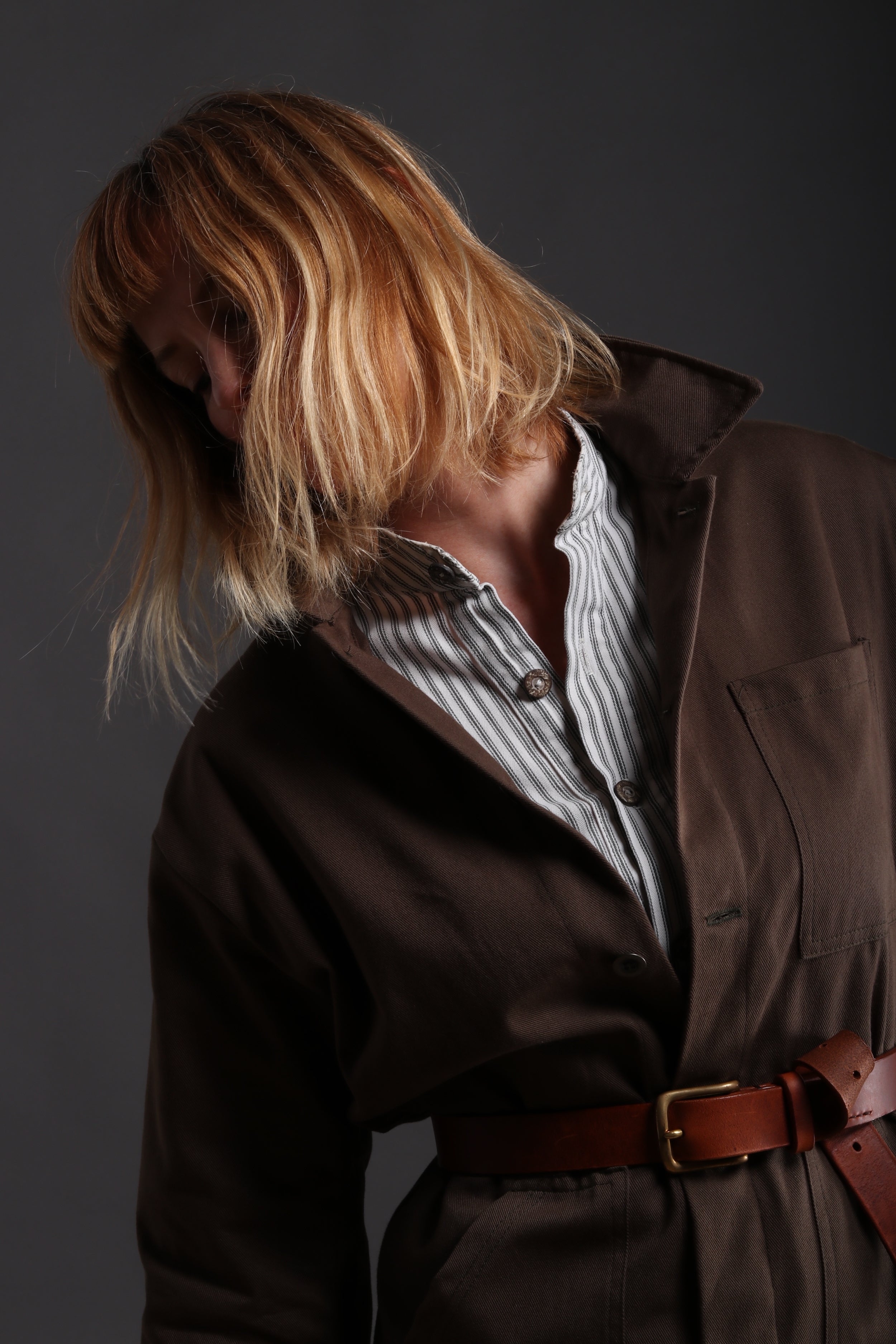 Sienna wears Carrier Company Boiler Suit in Olive Drill with Collarless Work Shirt in Ticking, Wool Hat and Chestnut Leather Belt