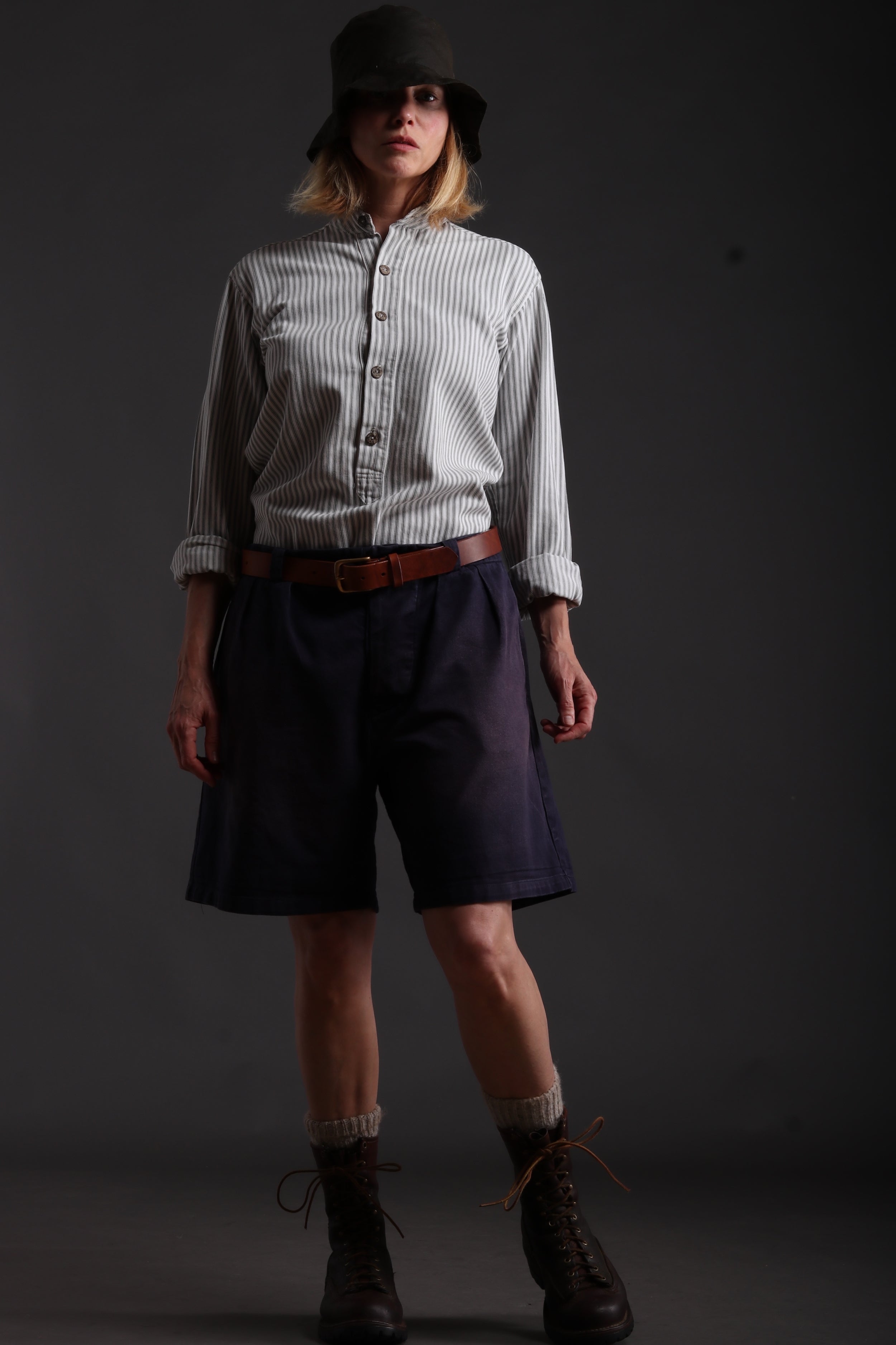 Woman wears Carrier Company Grandpa Shorts in Navy with Collarless Ticking Work Shirt