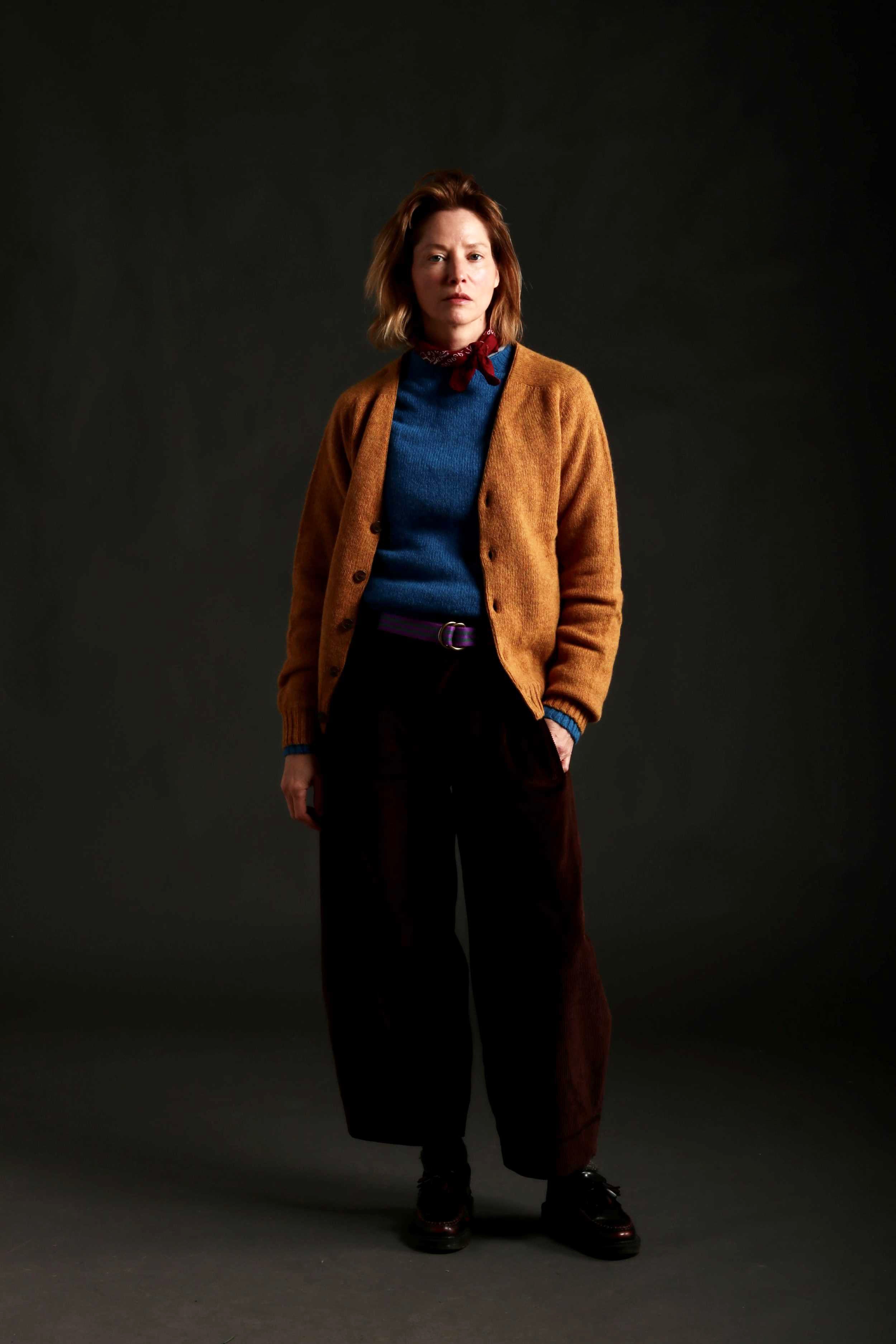 Woman Wears V Neck Button Down Cardigan in Cumin with Shetland Lambswool Jumper in Cyan and Dutch Trouser in Corduroy