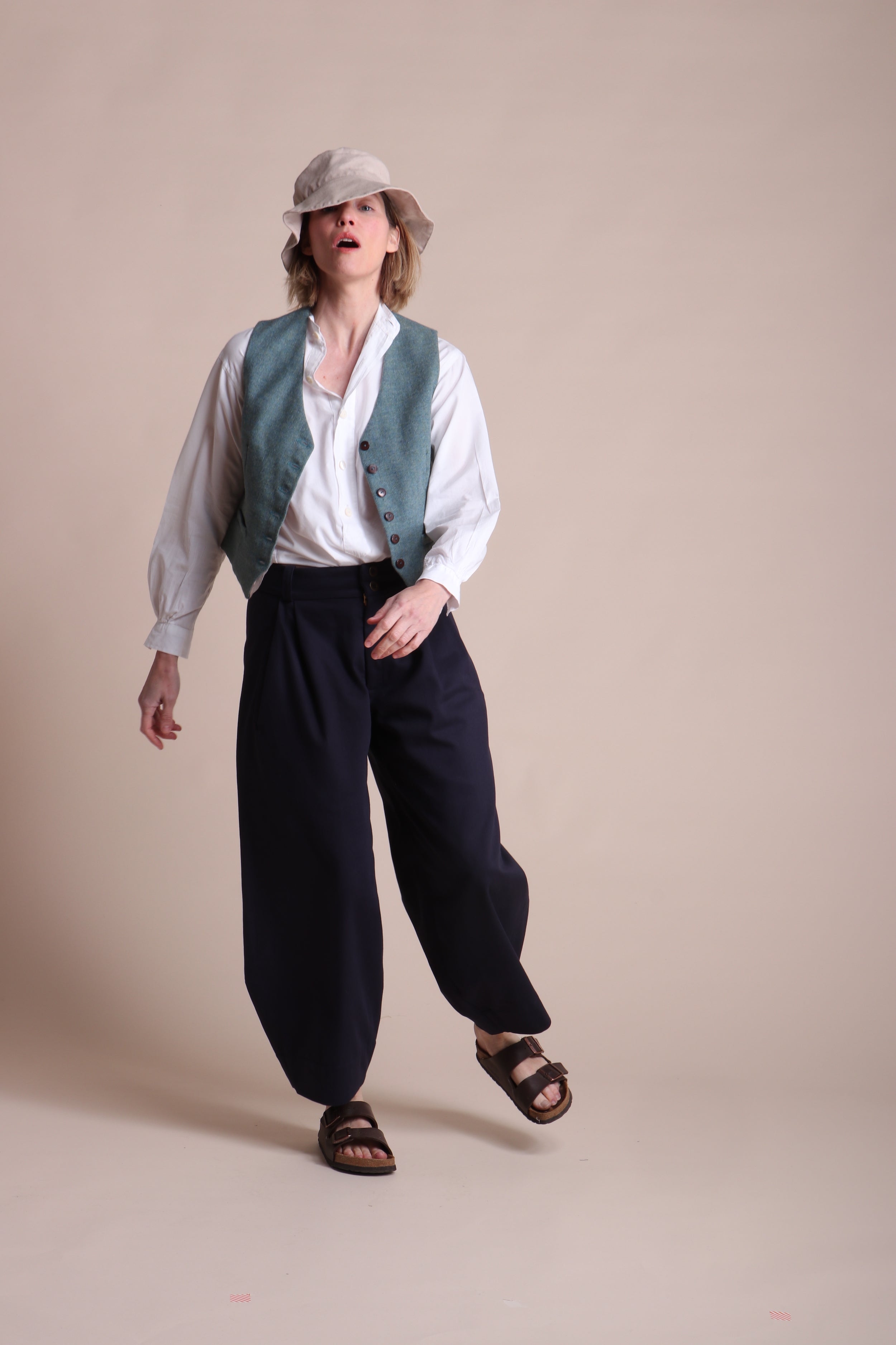 Woman wears Carrier Company Women's Wool Waistcoat in Marine with Lightweight Collarless Shirt and Dutch Trouser in Navy Cotton Drill