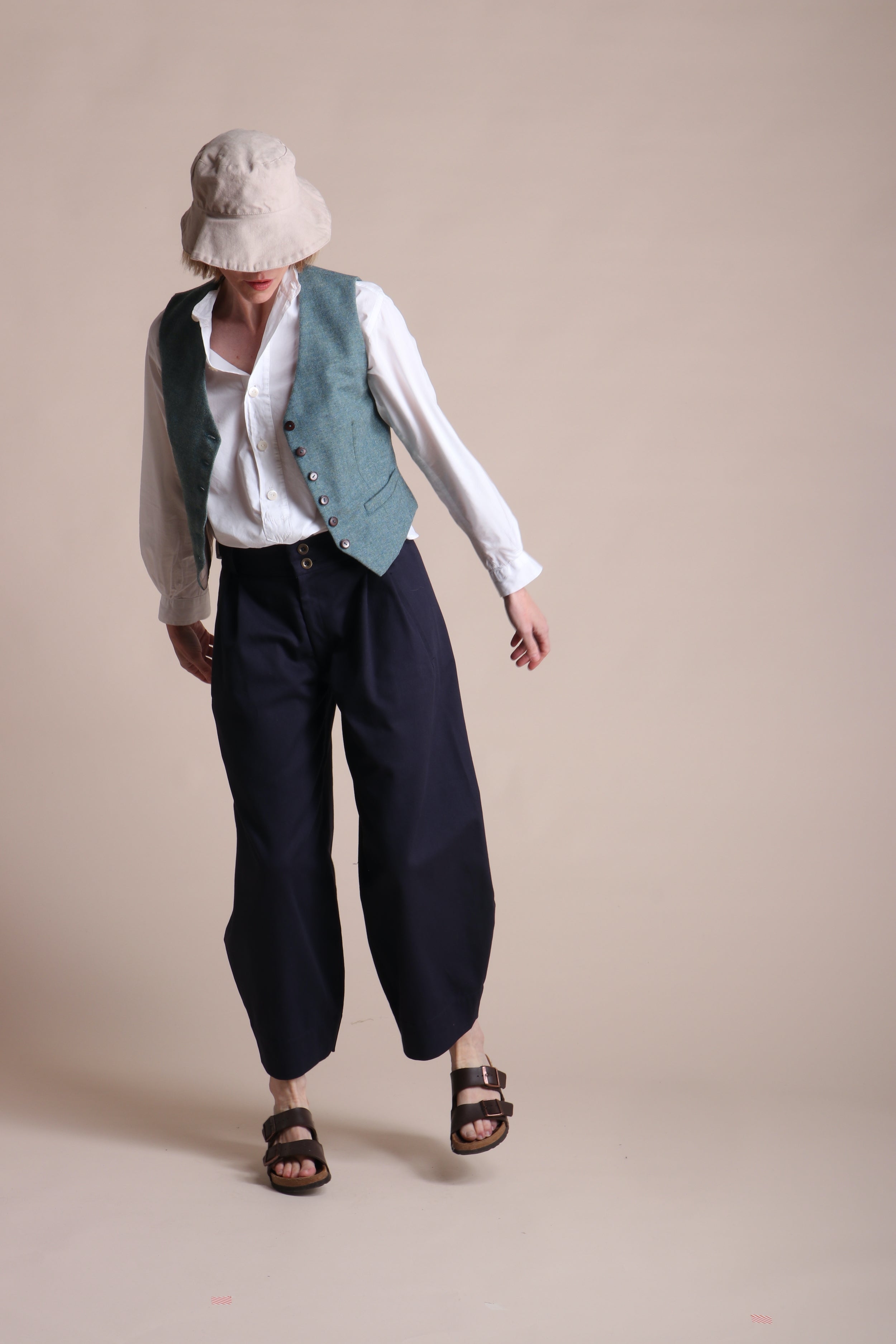 Woman wearing Carrier Company Dutch trouser In Navy Cotton Drill  and Lightweight Collaless Work Shirt, Women's Wool Waistcoat and Cotton Sun Hat