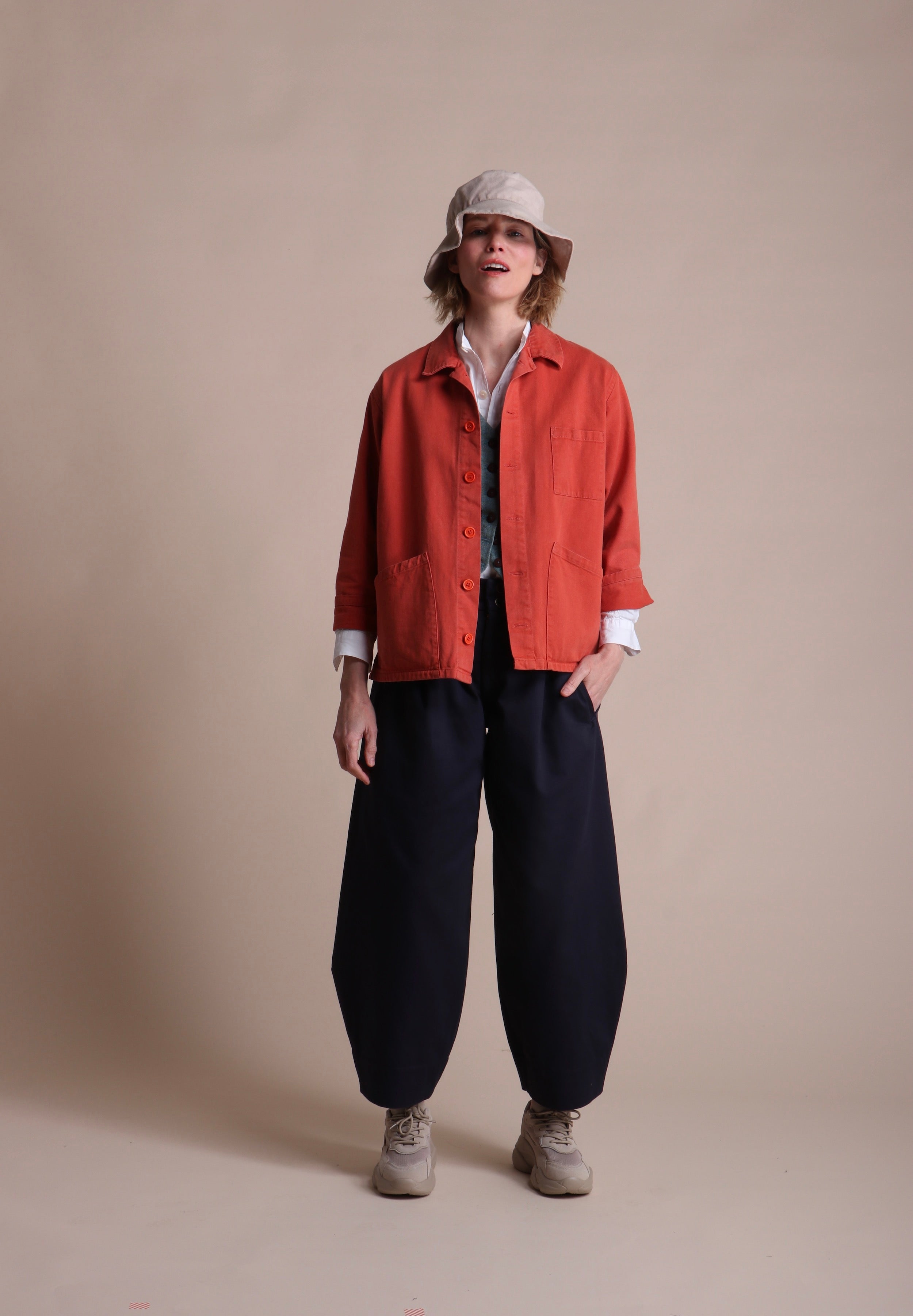 Woman wearing Carrier Company Norfolk Work Jacket in Orange with Dutch Trouser