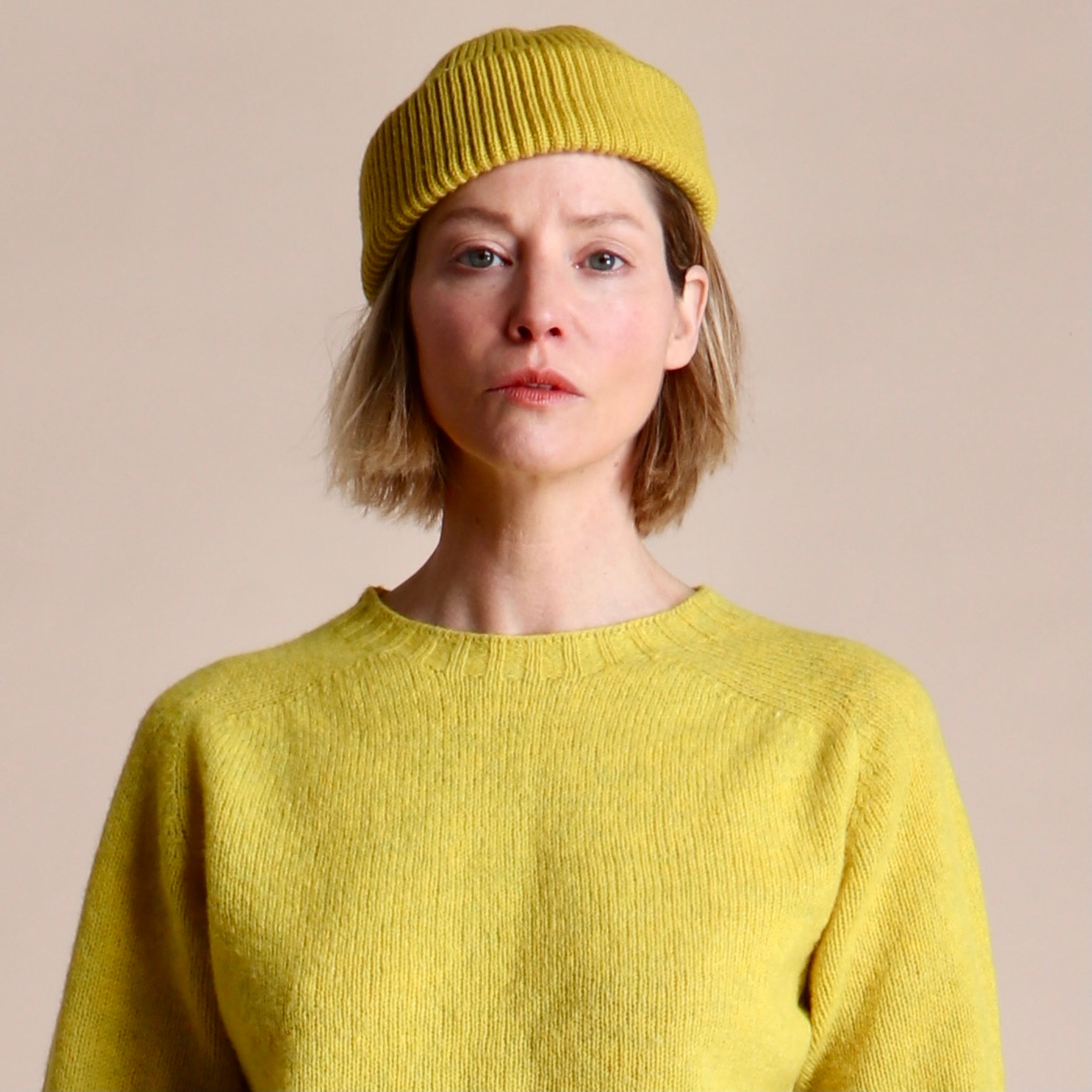 Woman wearing Carrier Company Wool Hat in Yellow and Shetland Lambswool Jumper